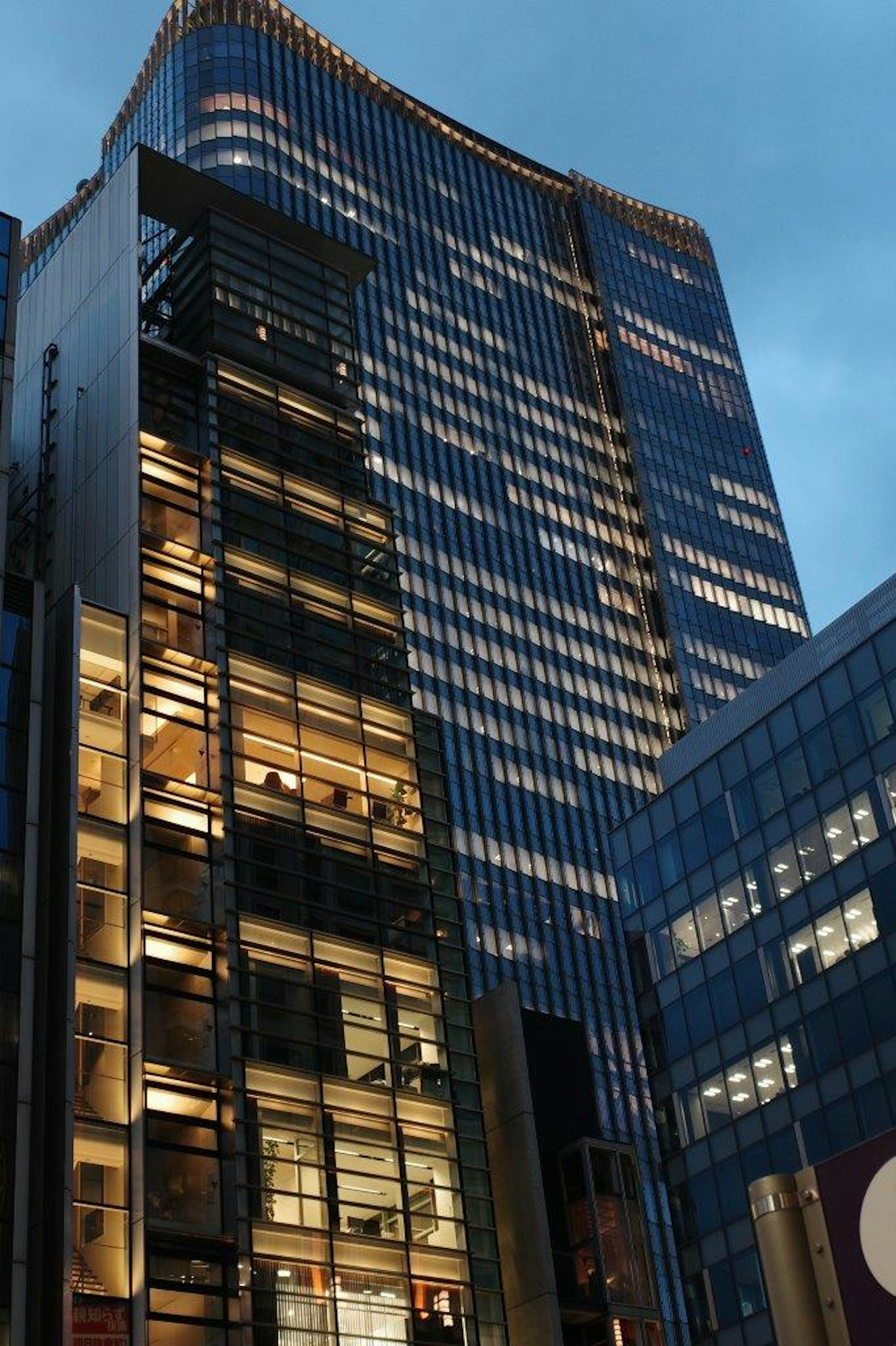 Night view of towering skyscrapers with illuminated windows