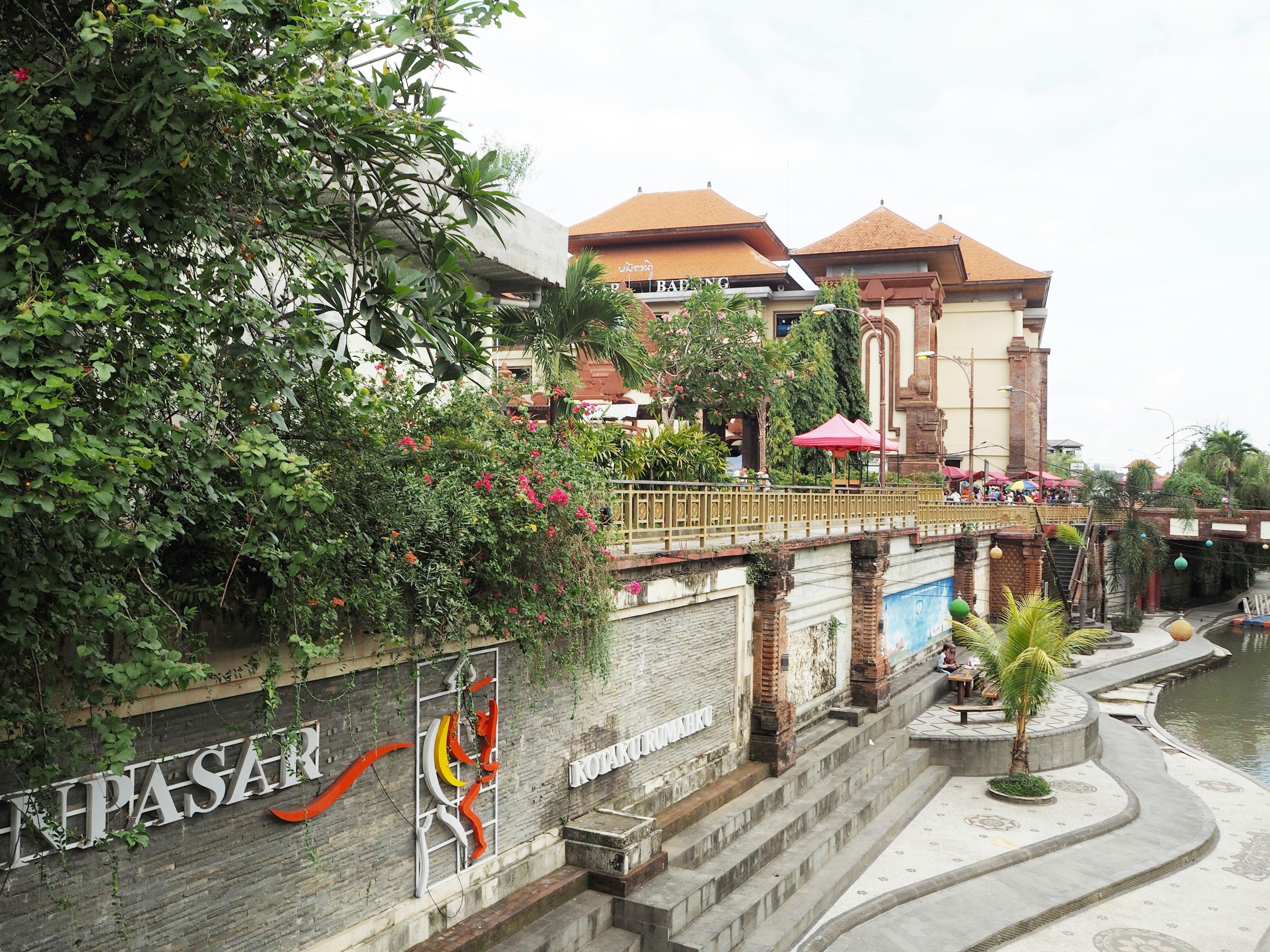 Scenic view of riverside buildings and lush greenery