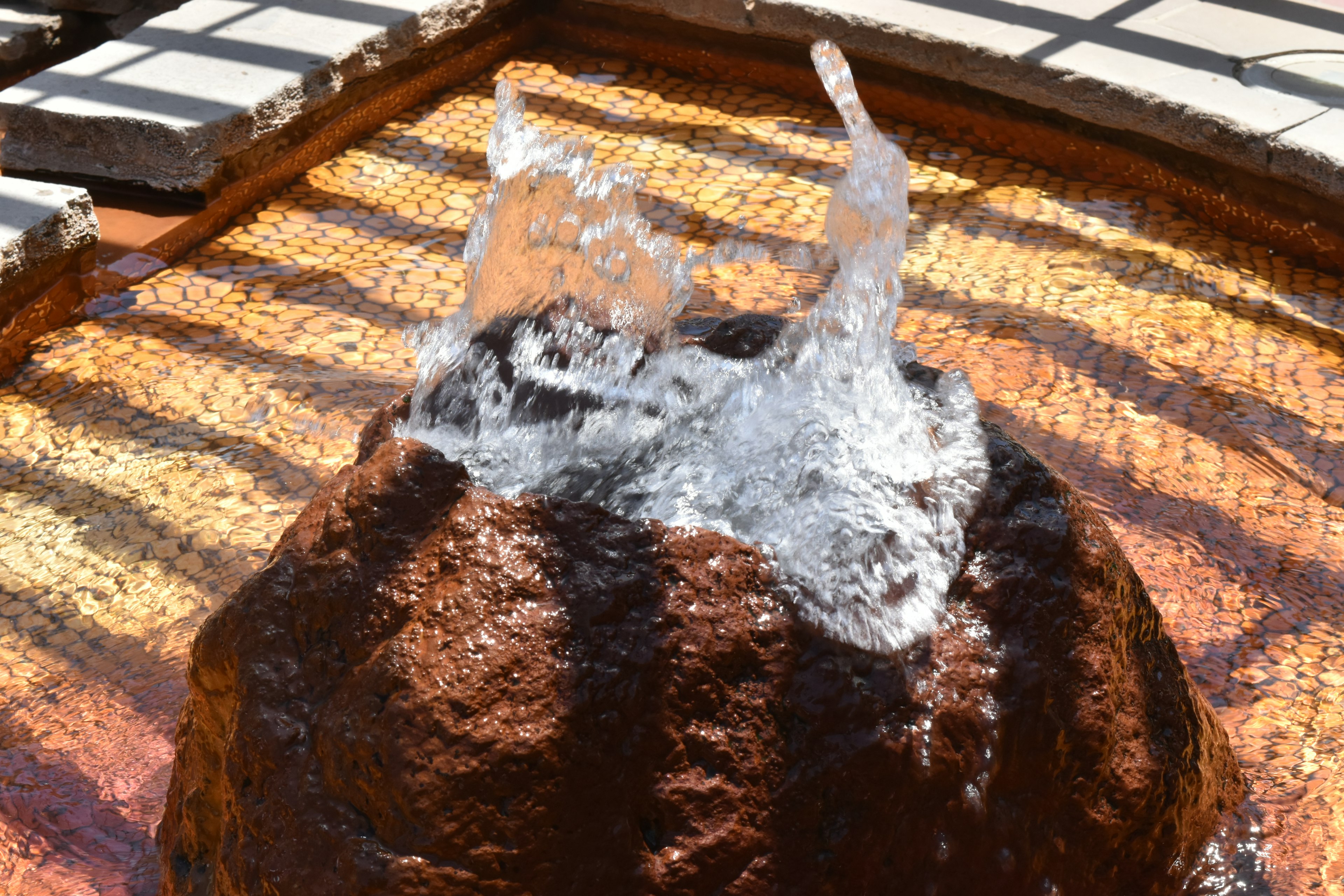 Beautiful fountain with water cascading over a rock