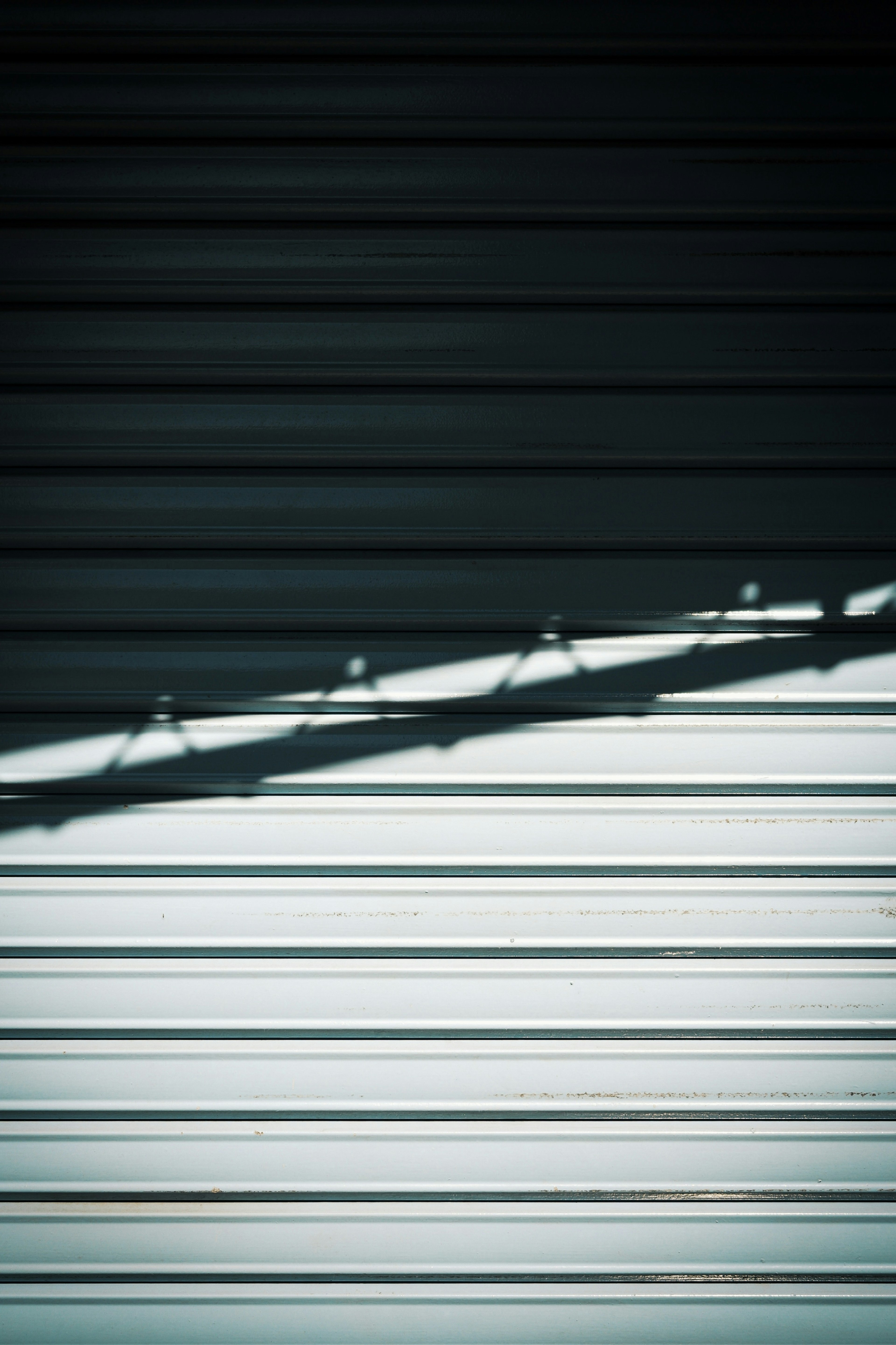 Shadow of a shutter on a metallic surface