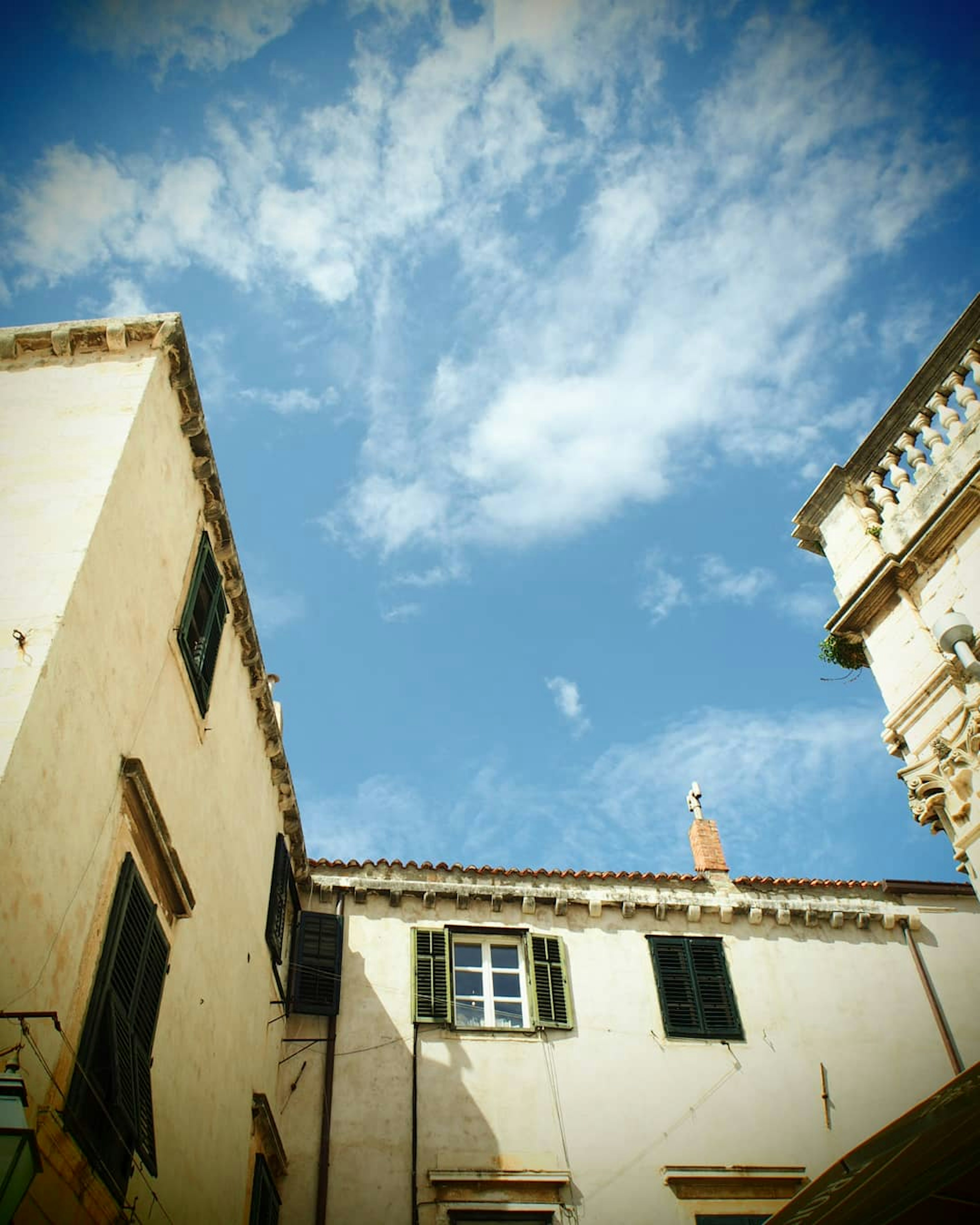 Old buildings with blue sky and clouds in the background