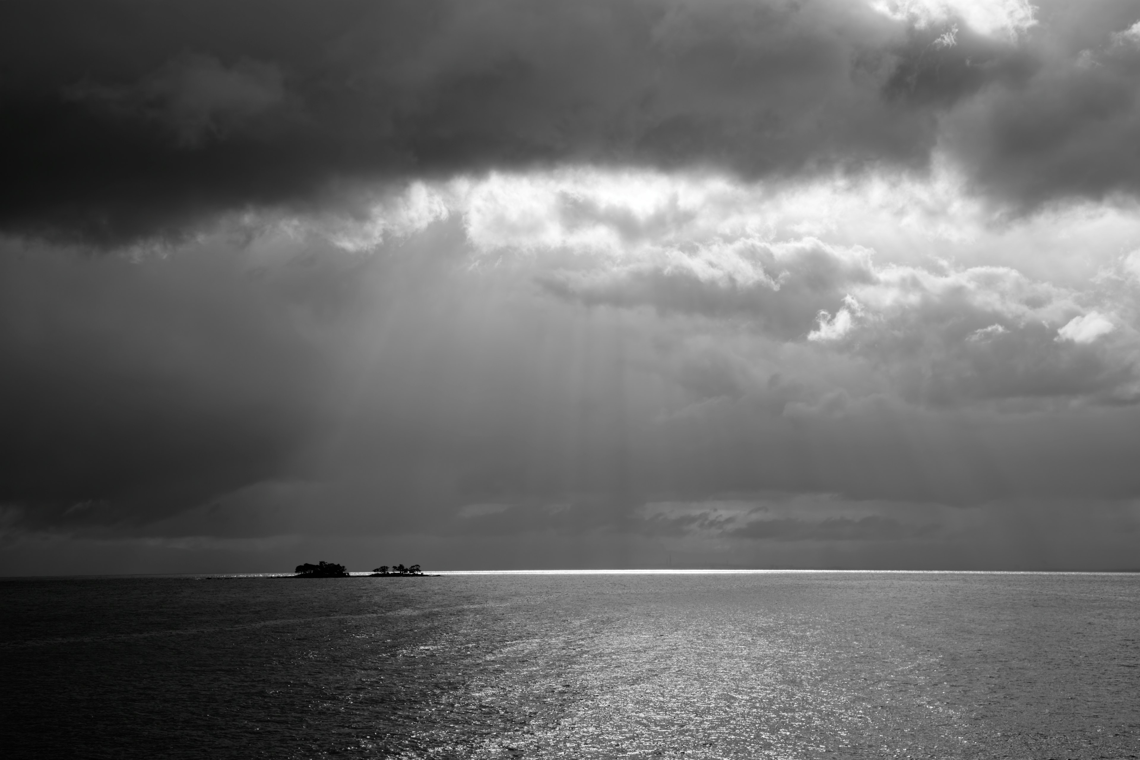 陰雲密布的海景和遠處的船