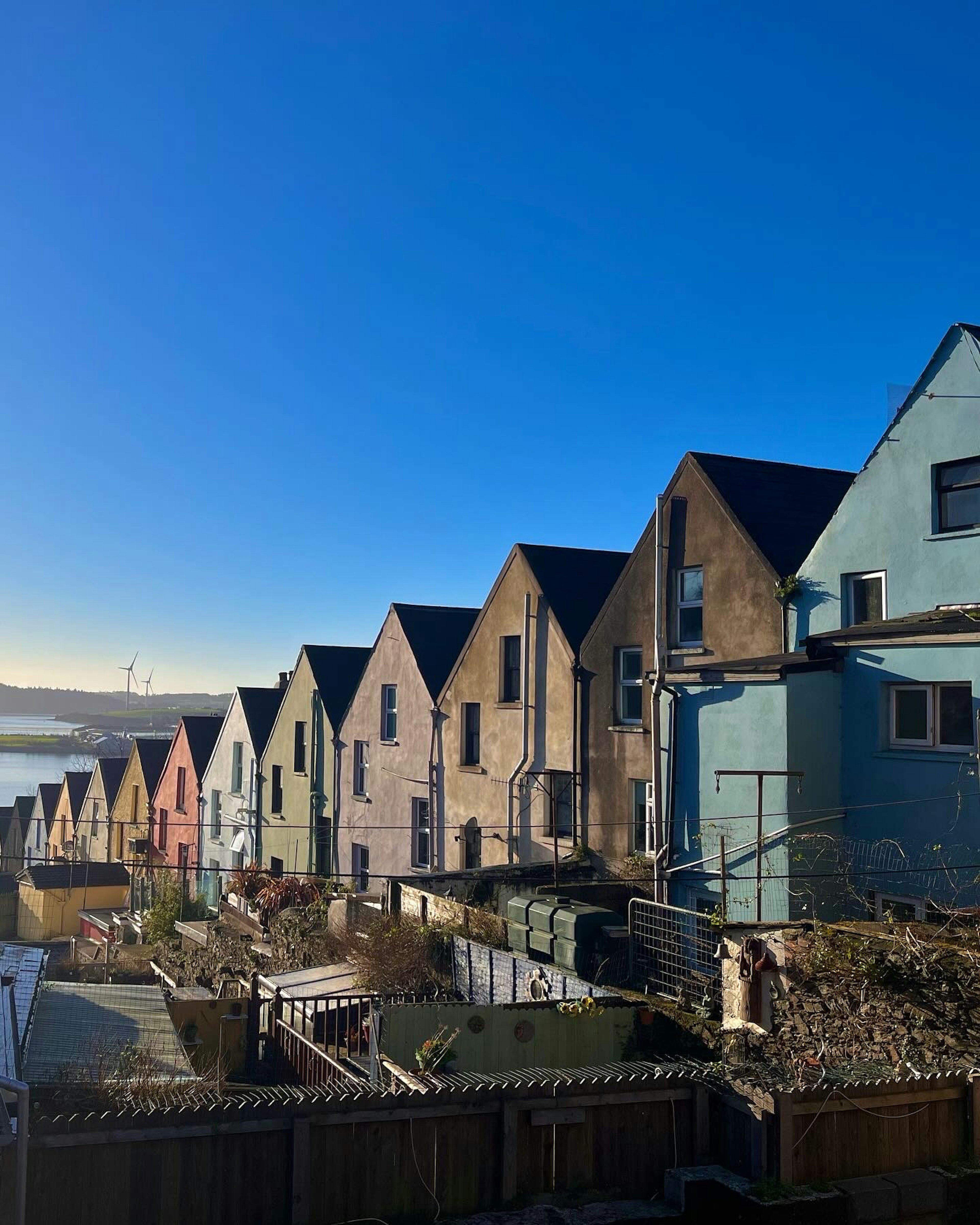 Colorful row of houses under a clear blue sky