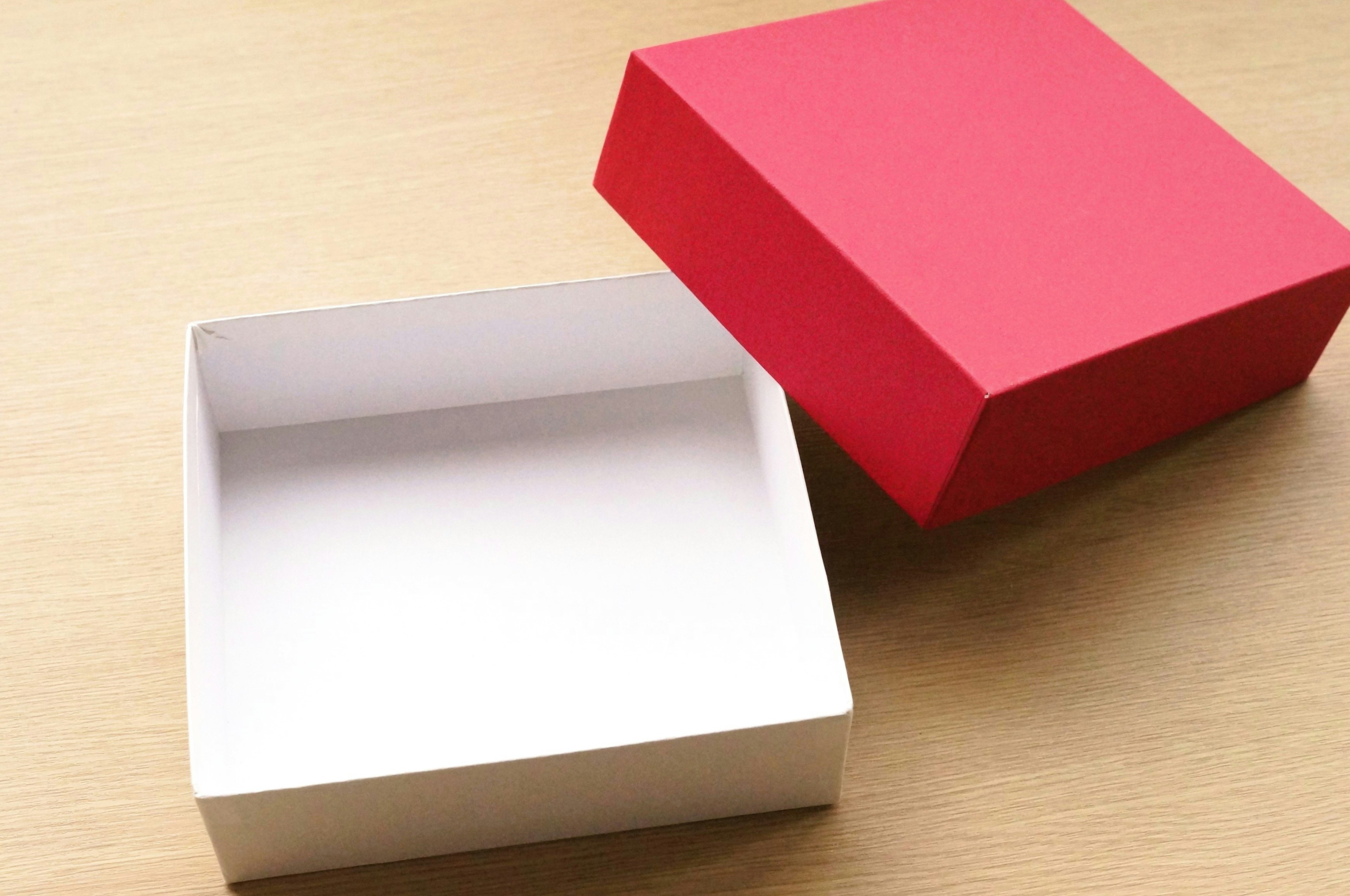 Red lid on a white box and an empty box