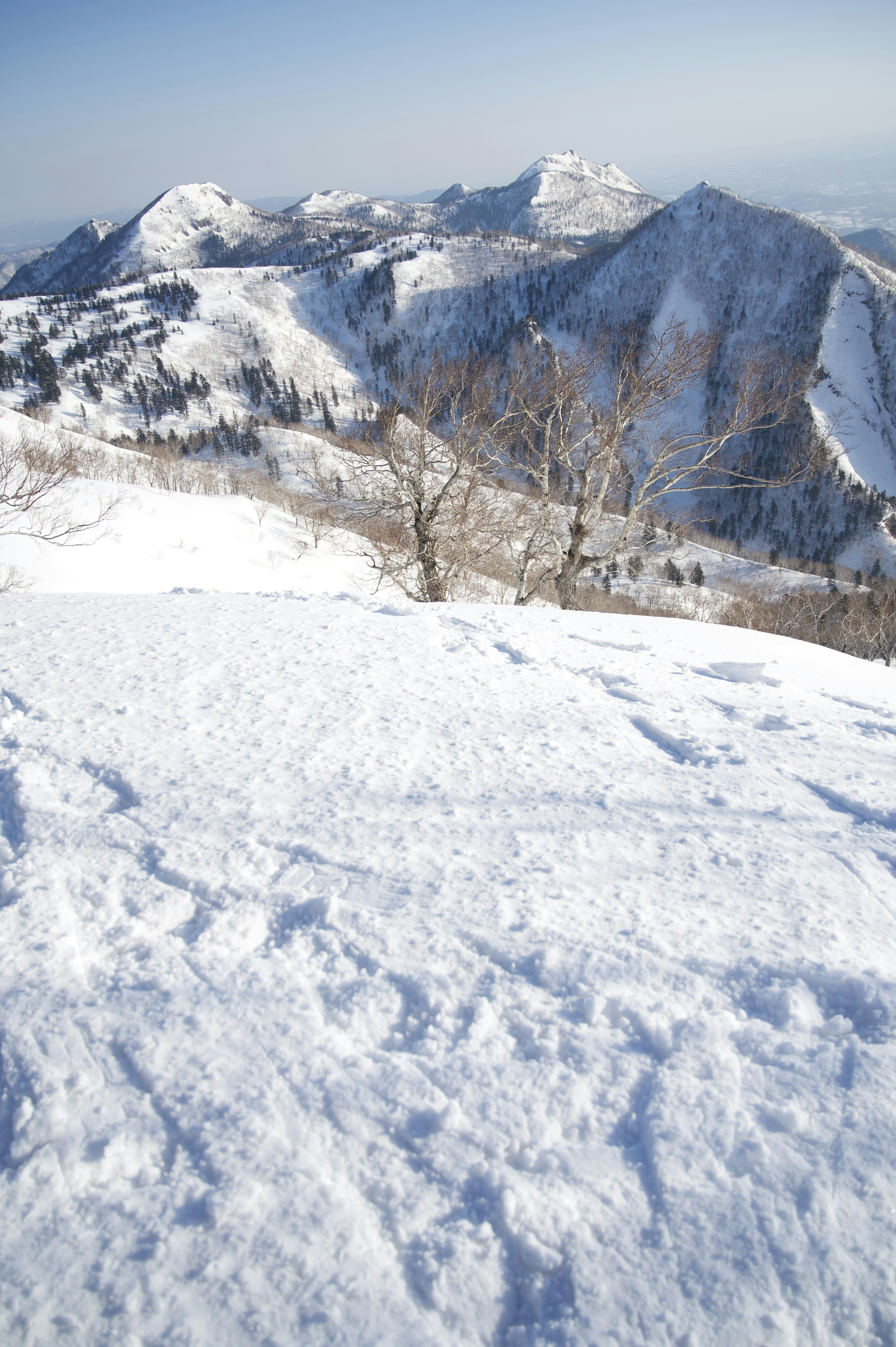 Snow-covered mountain landscape with a clear blue sky