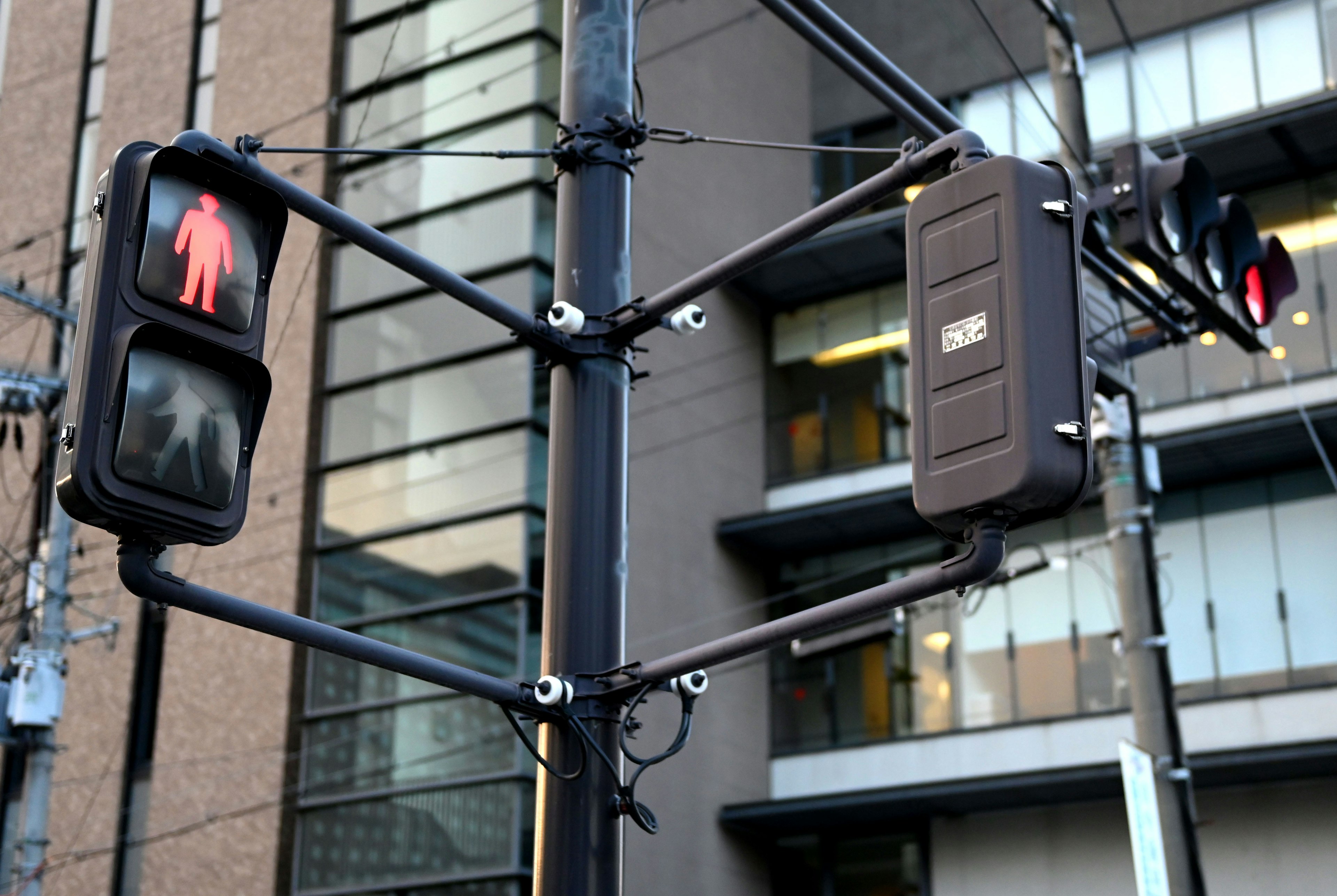 Image of a pedestrian signal and red traffic light at an intersection