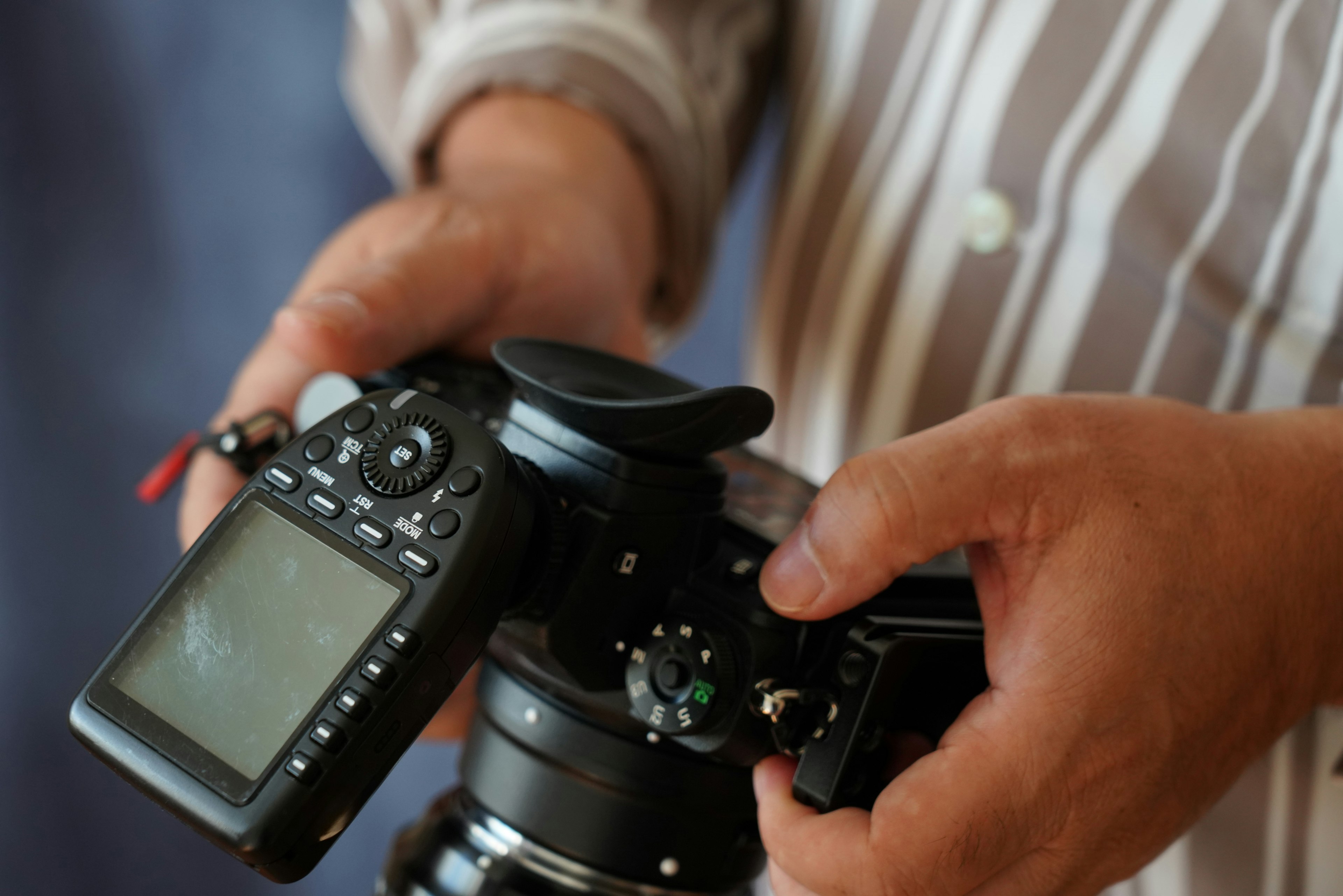 Close-up of hands holding a camera