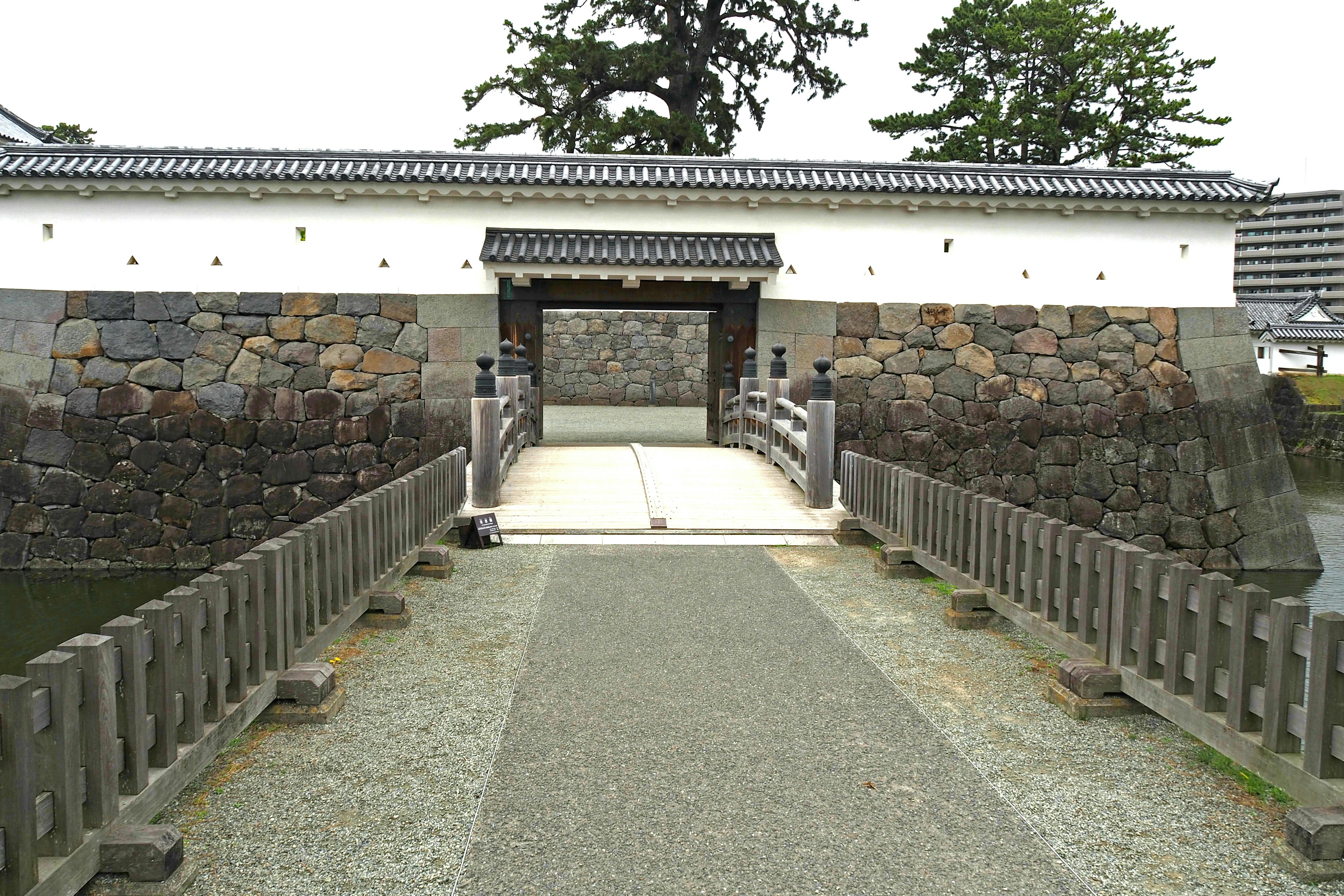 Bridge leading to castle gate with stone walls