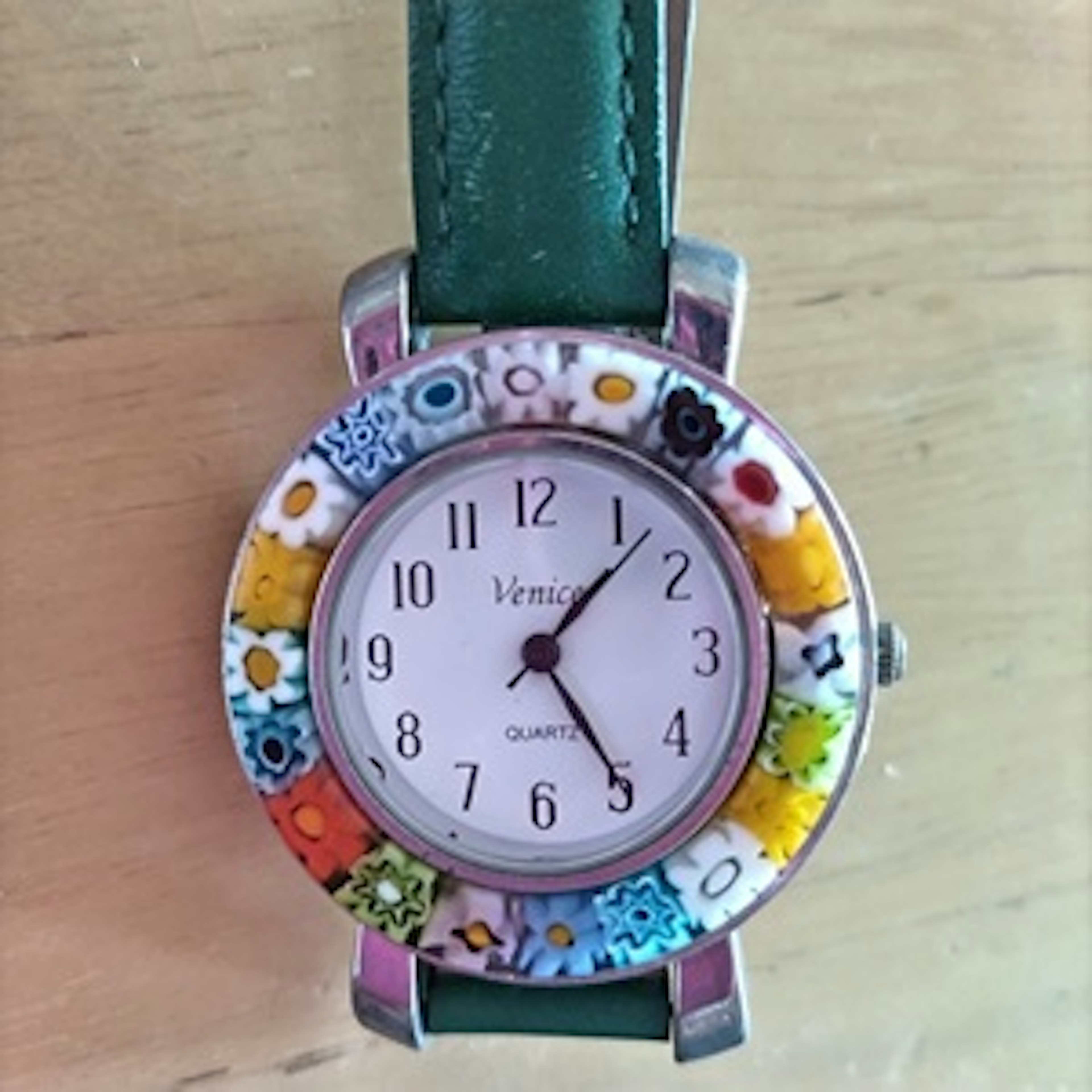 Colorful floral patterned watch with green strap and quartz movement