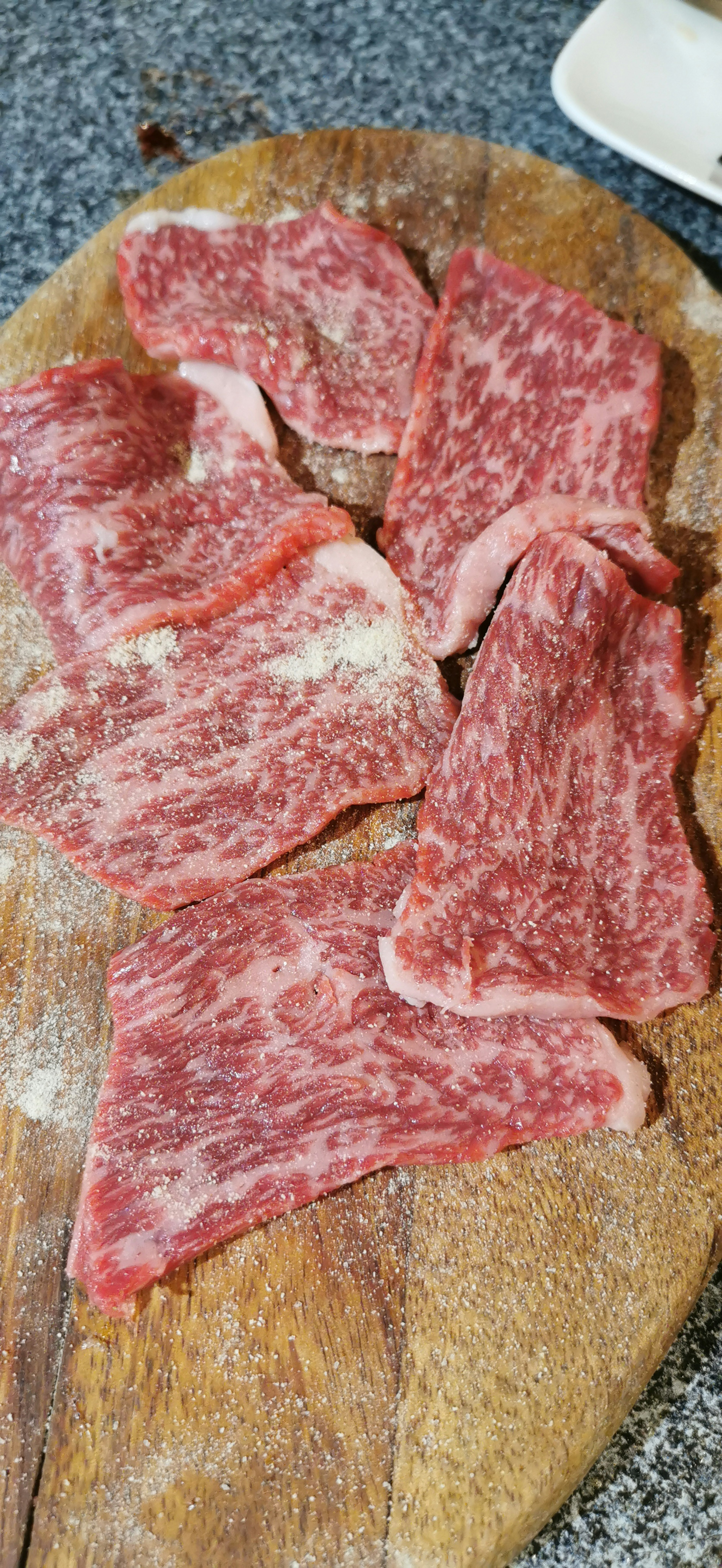 Succulent slices of Wagyu beef arranged on a wooden cutting board