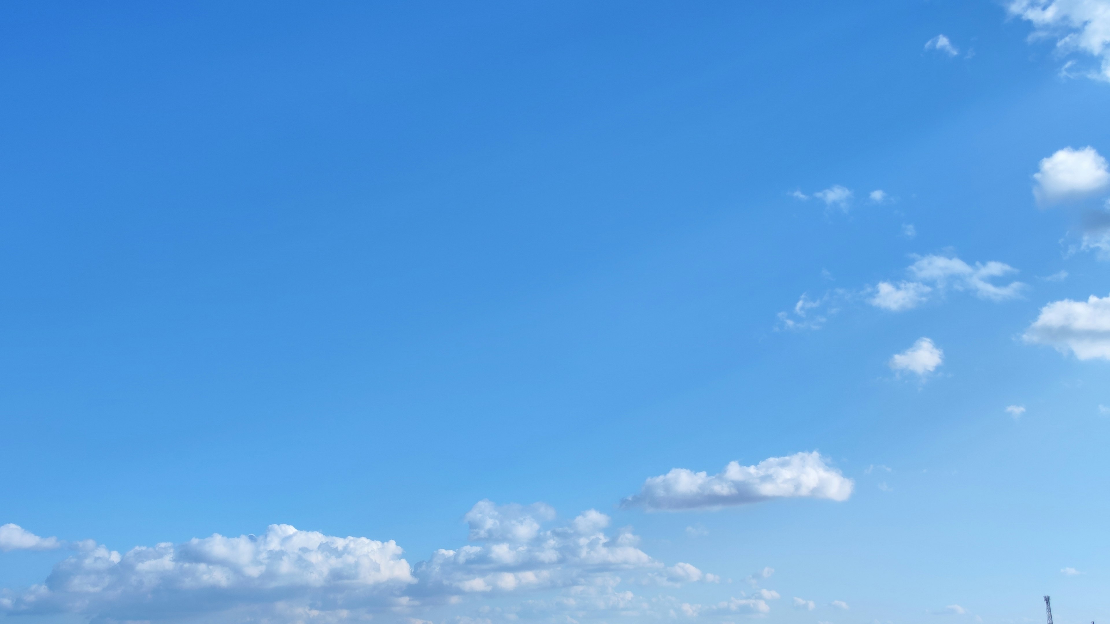 Bright blue sky with fluffy white clouds