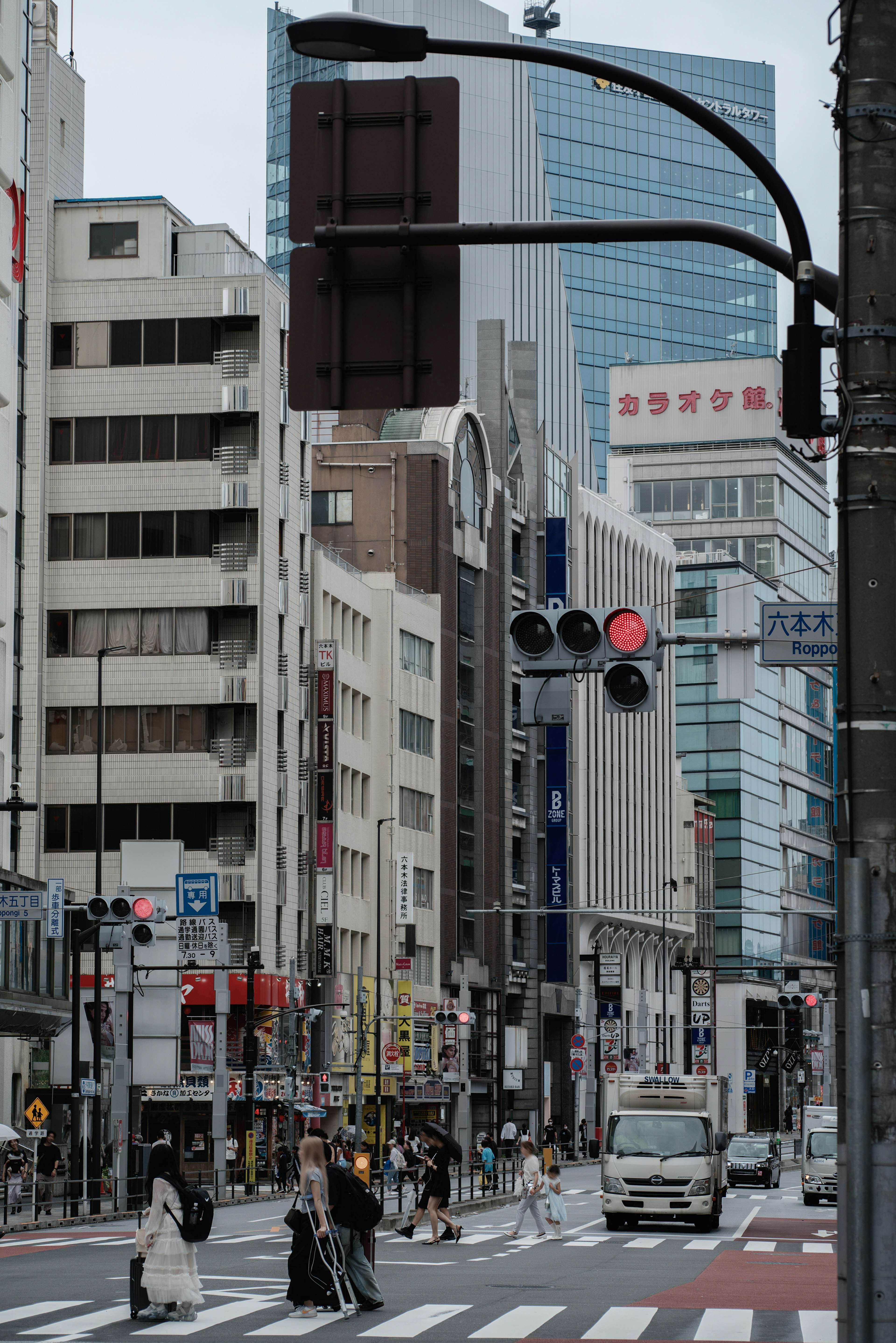 Cityscape of Tokyo featuring traffic signals and pedestrian crossing