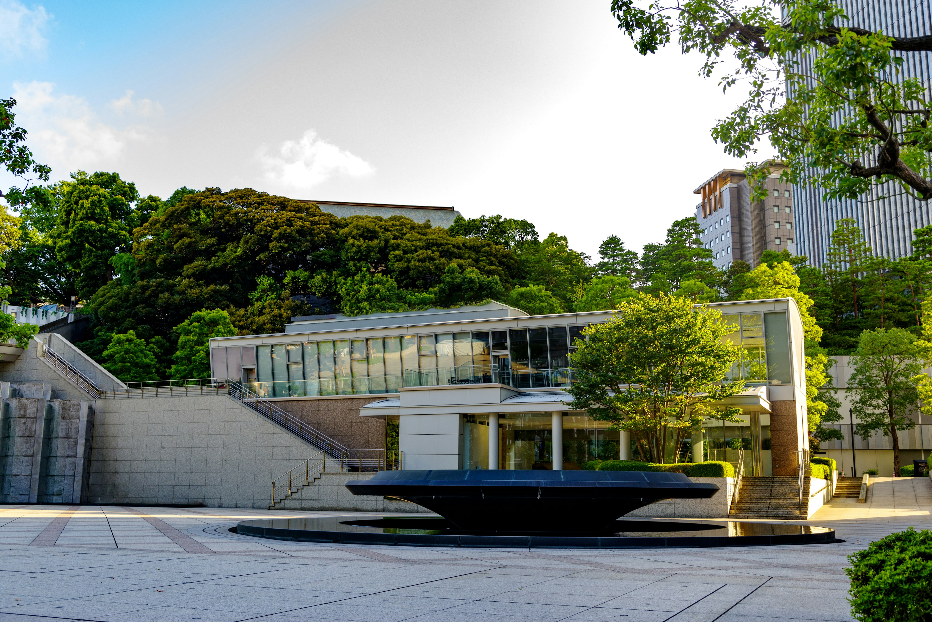 Modern architectural structure surrounded by lush greenery