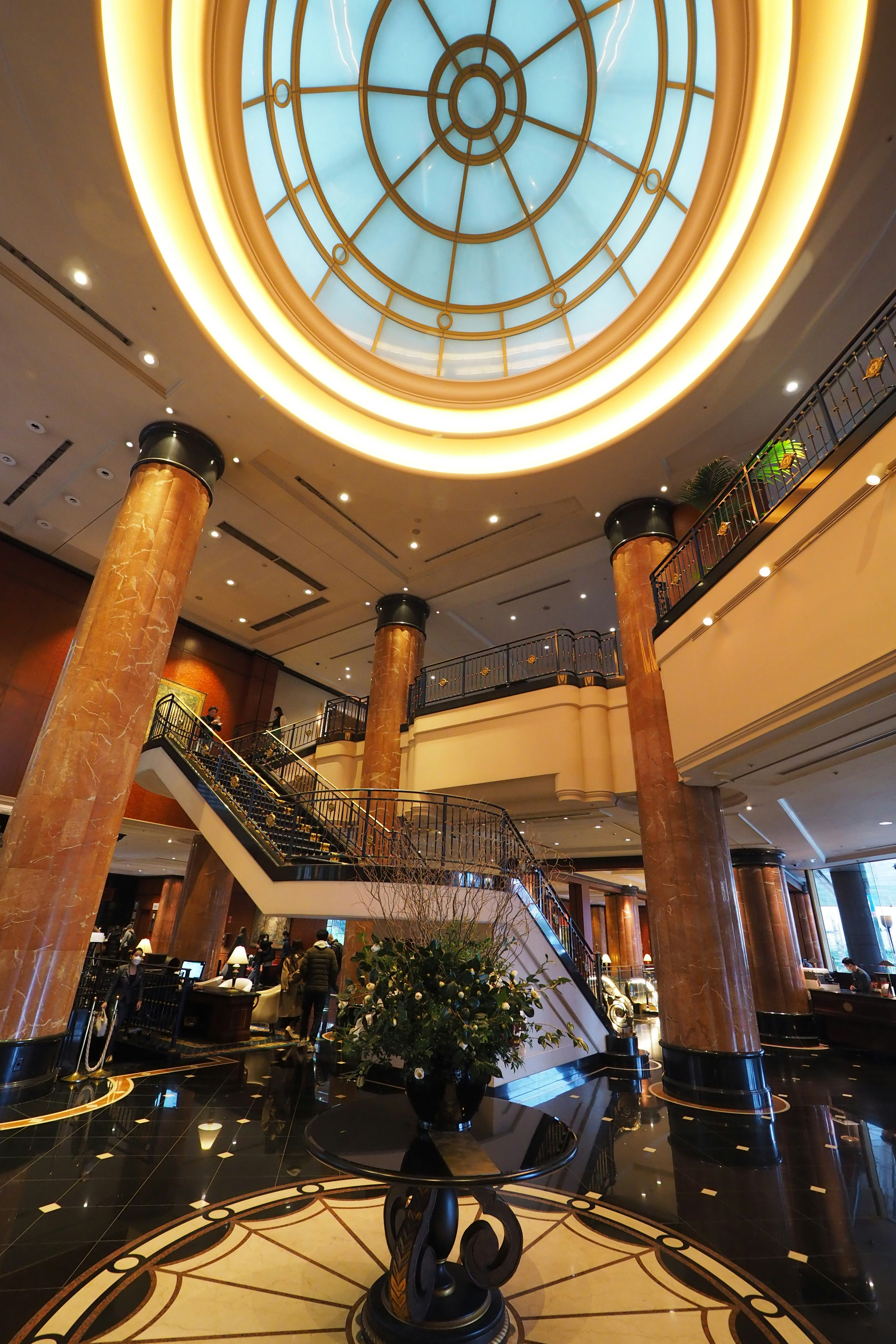 Luxurious lobby featuring a circular ceiling and marble columns