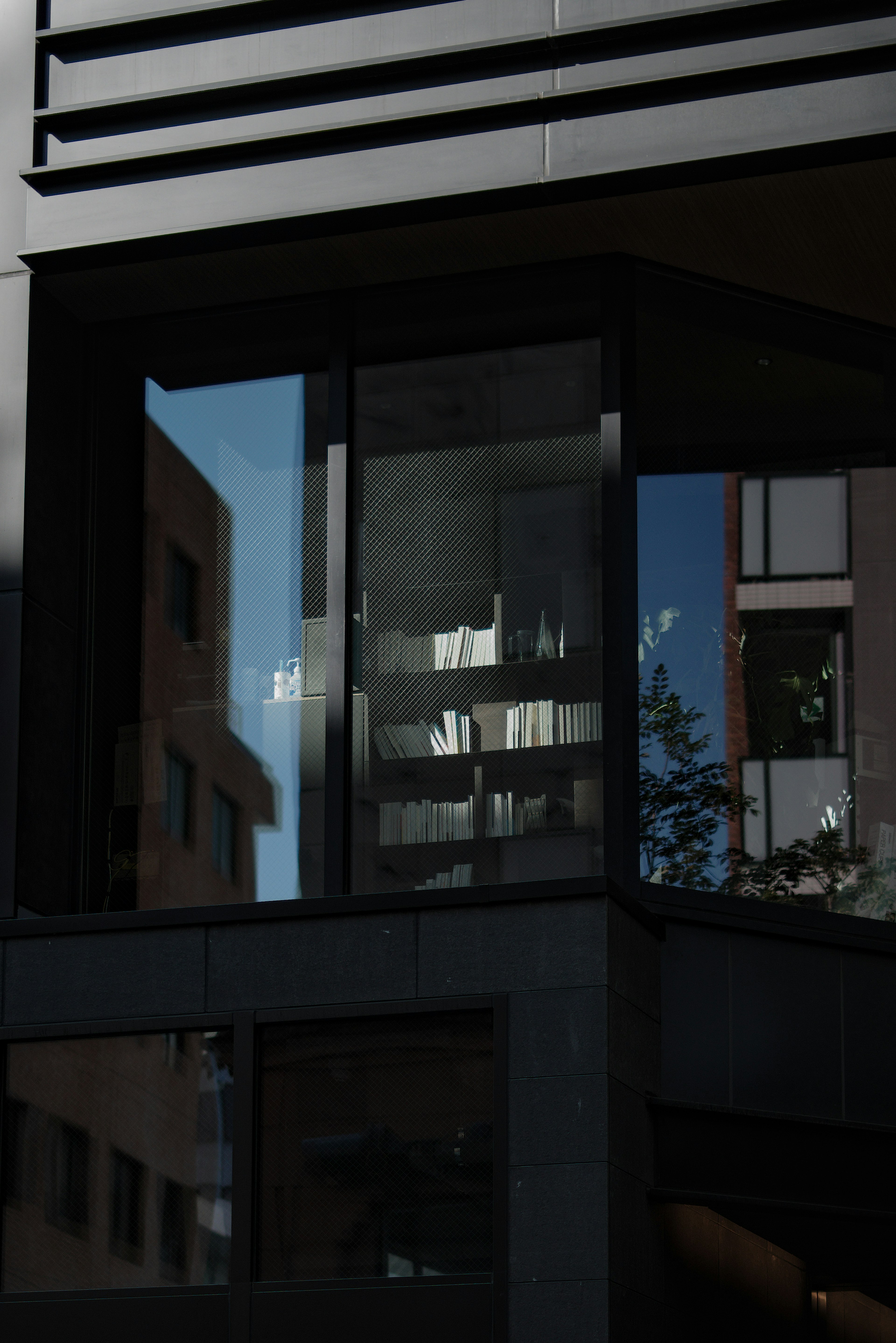 Modern building window reflecting surrounding scenery