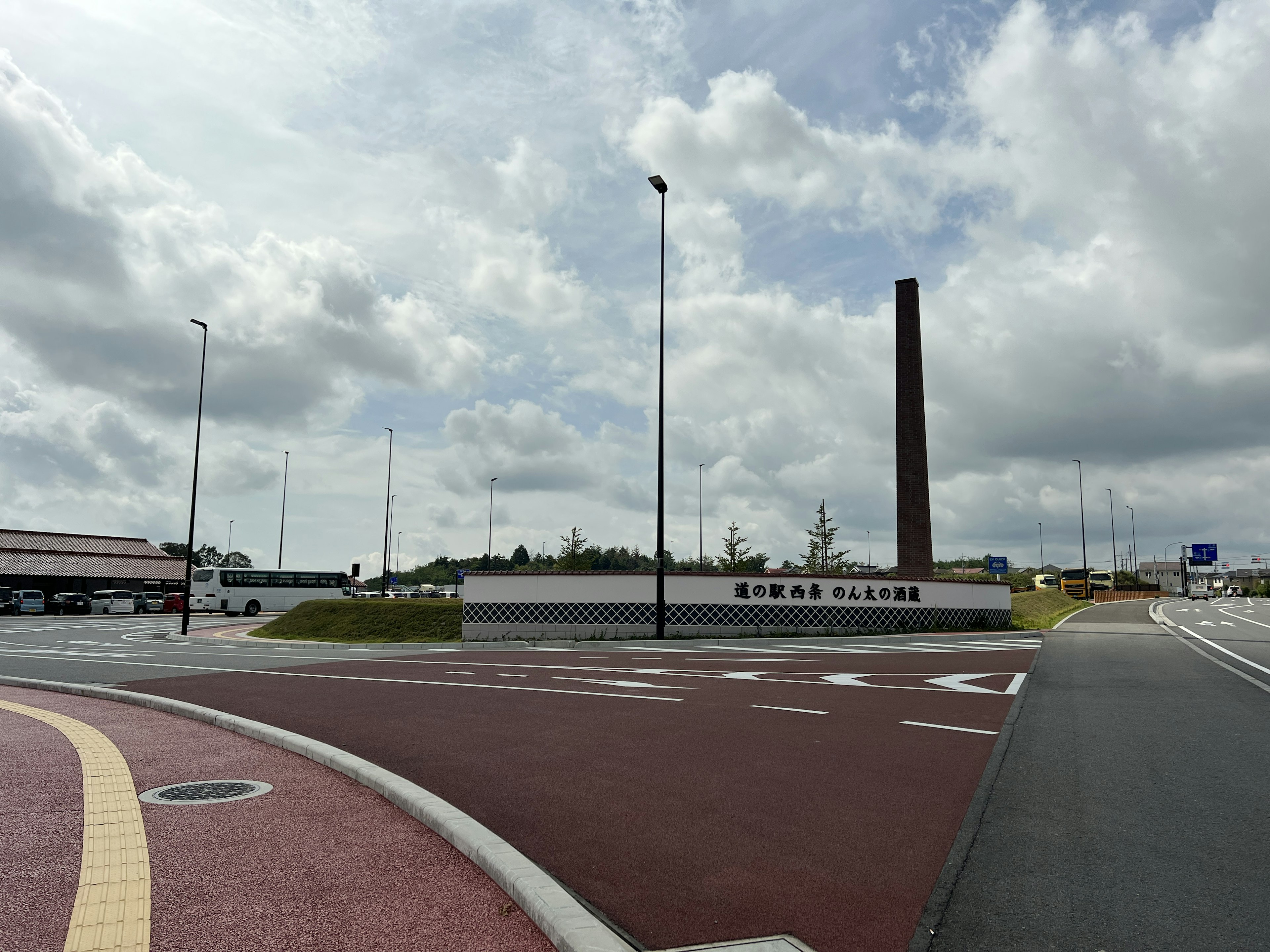 Sign of Emma Plaza at a road intersection with a chimney visible