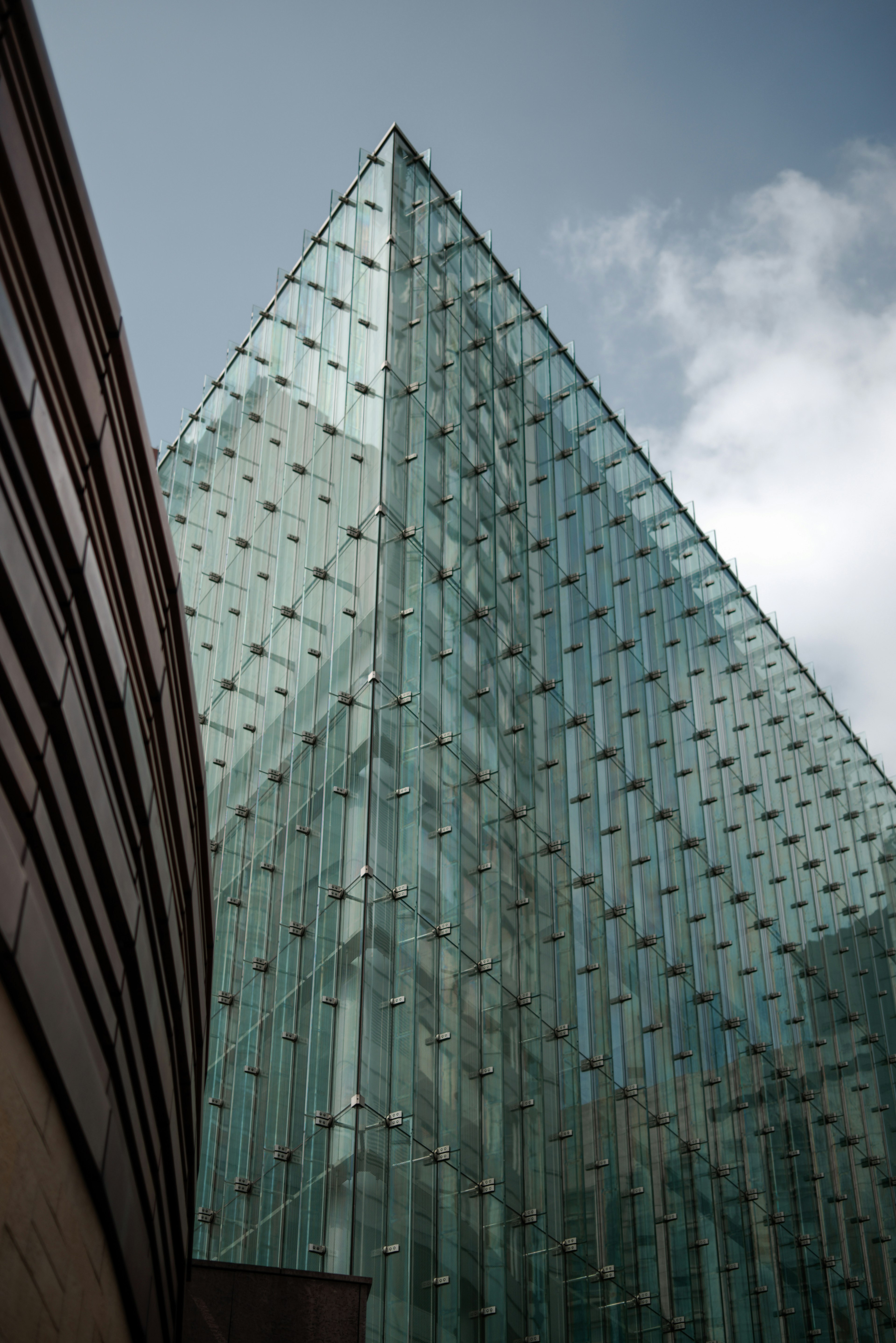 Glass triangular building with a curved wall