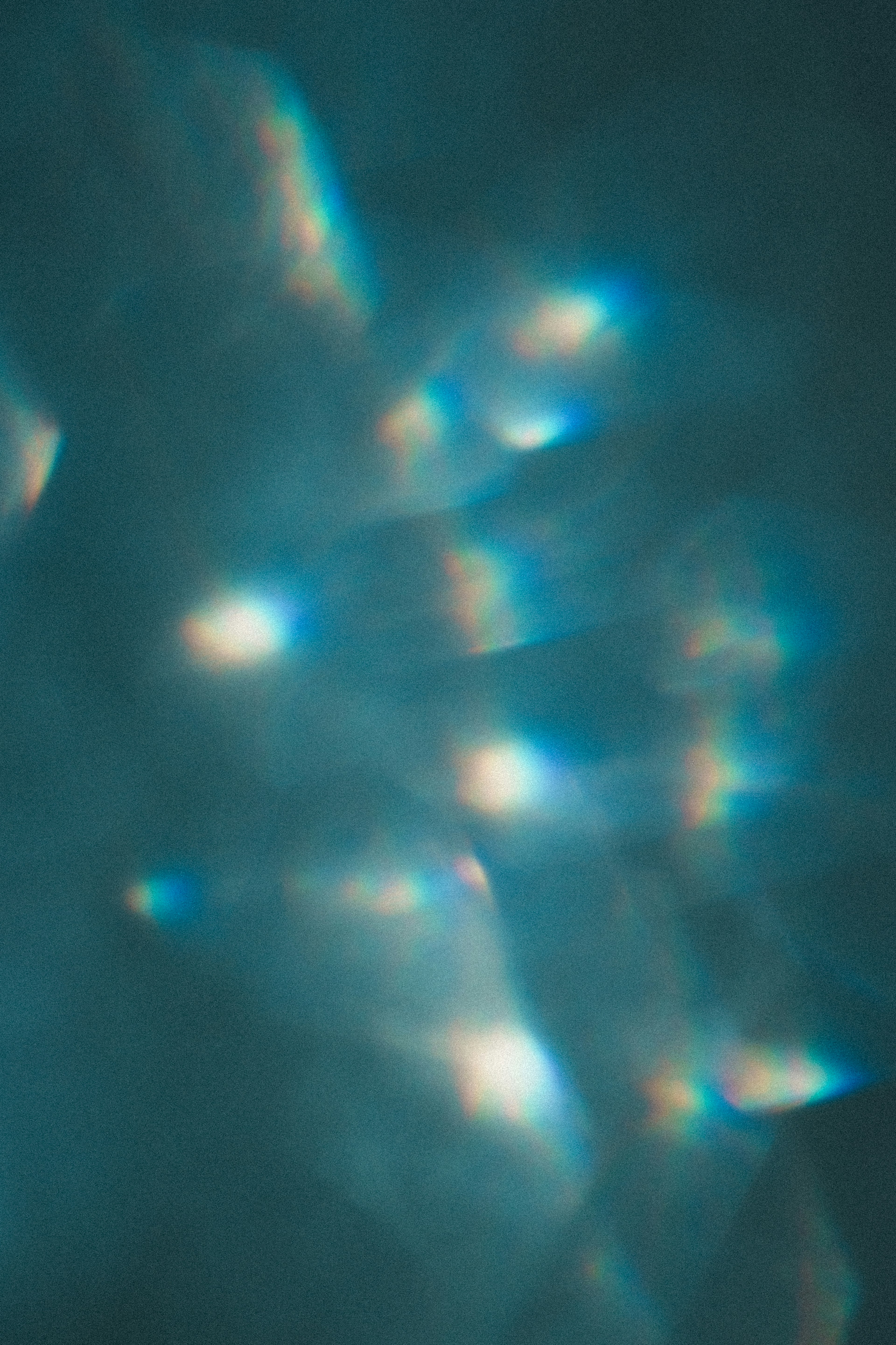 Abstract image with blue and white light reflections on a teal background