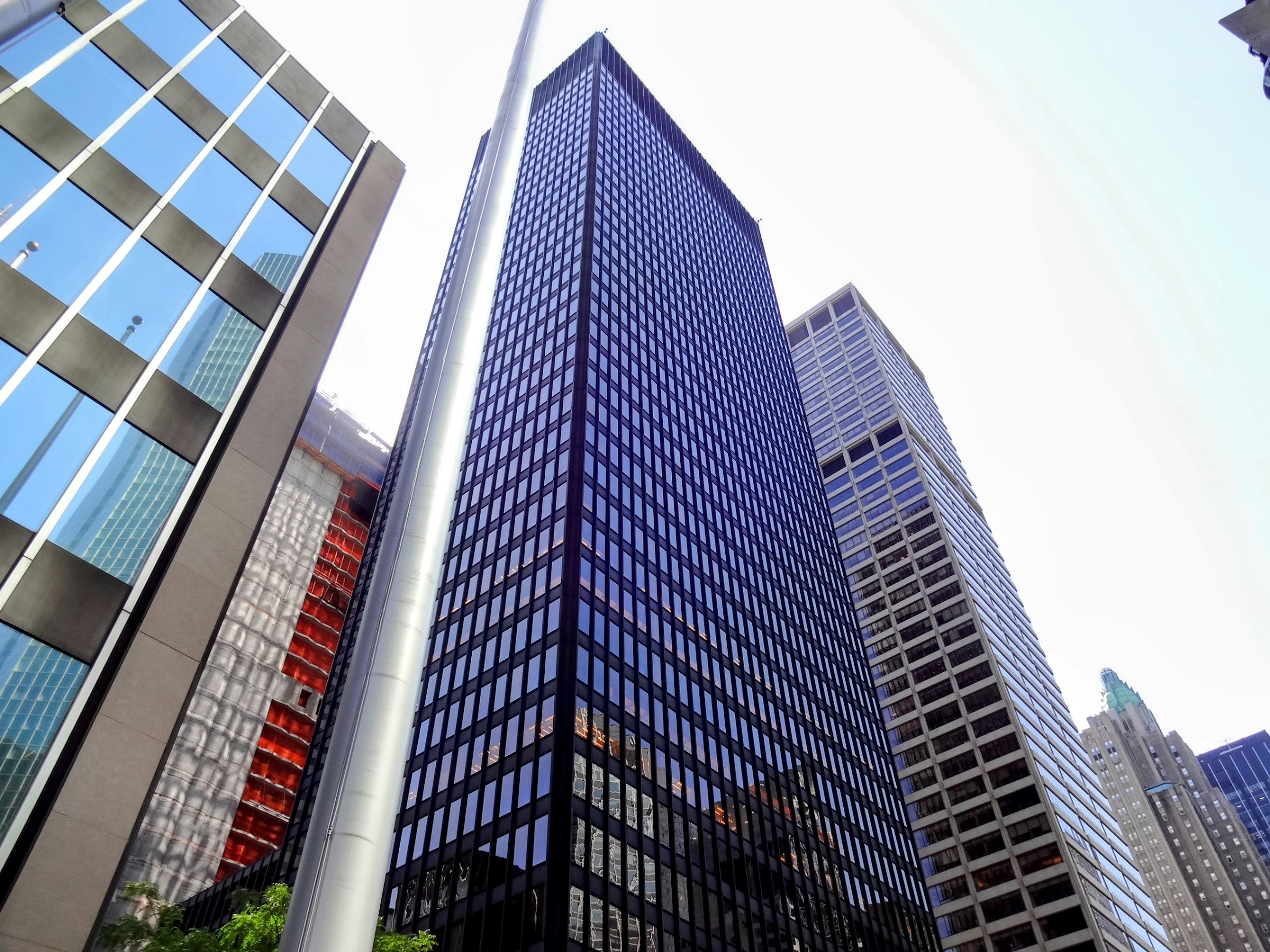 Cityscape featuring tall buildings, reflective glass surfaces, and modern architectural design