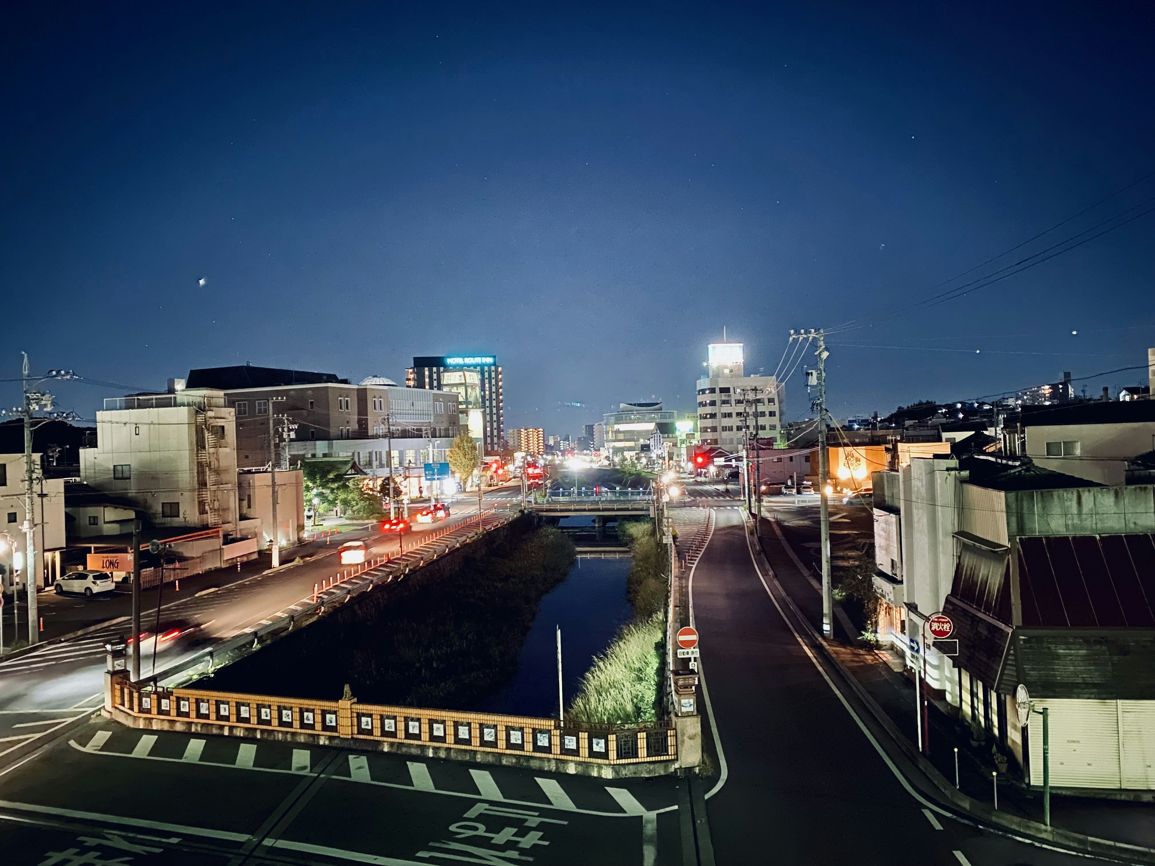 Night cityscape with bright streetlights and flowing cars featuring buildings and streets