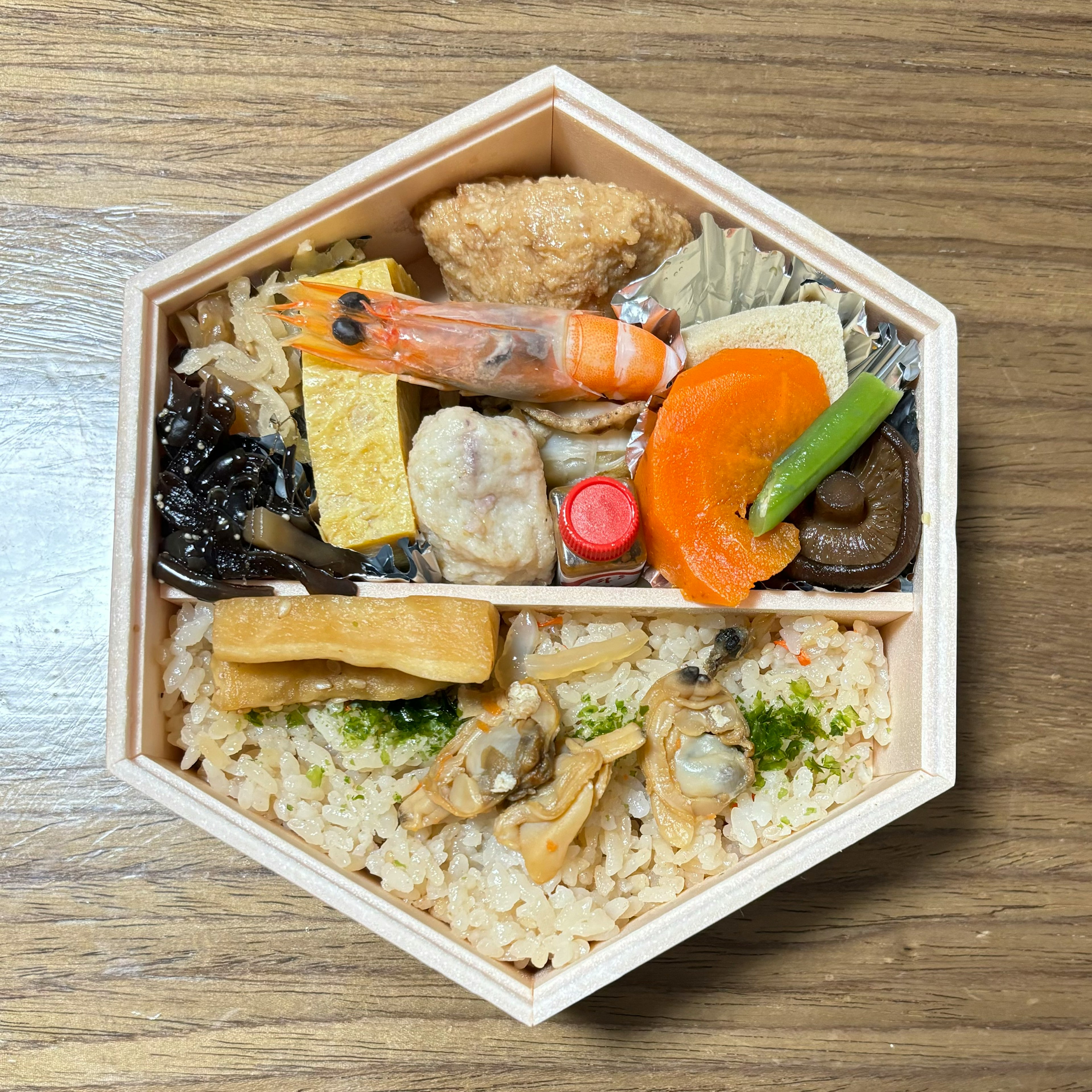 A beautifully arranged hexagonal bento box featuring various dishes