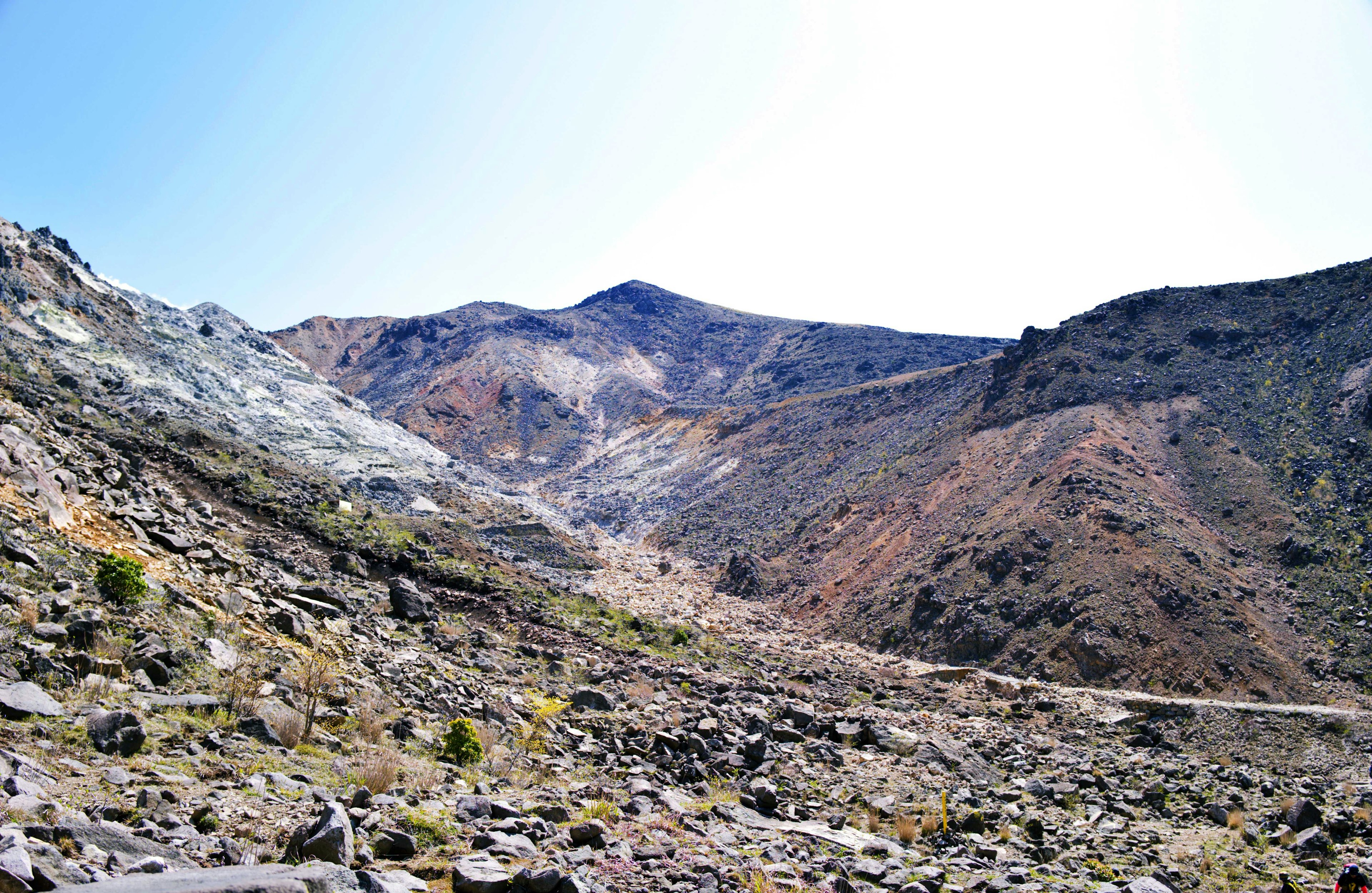 Rugged landscape featuring mountains with rocky terrain and sparse vegetation