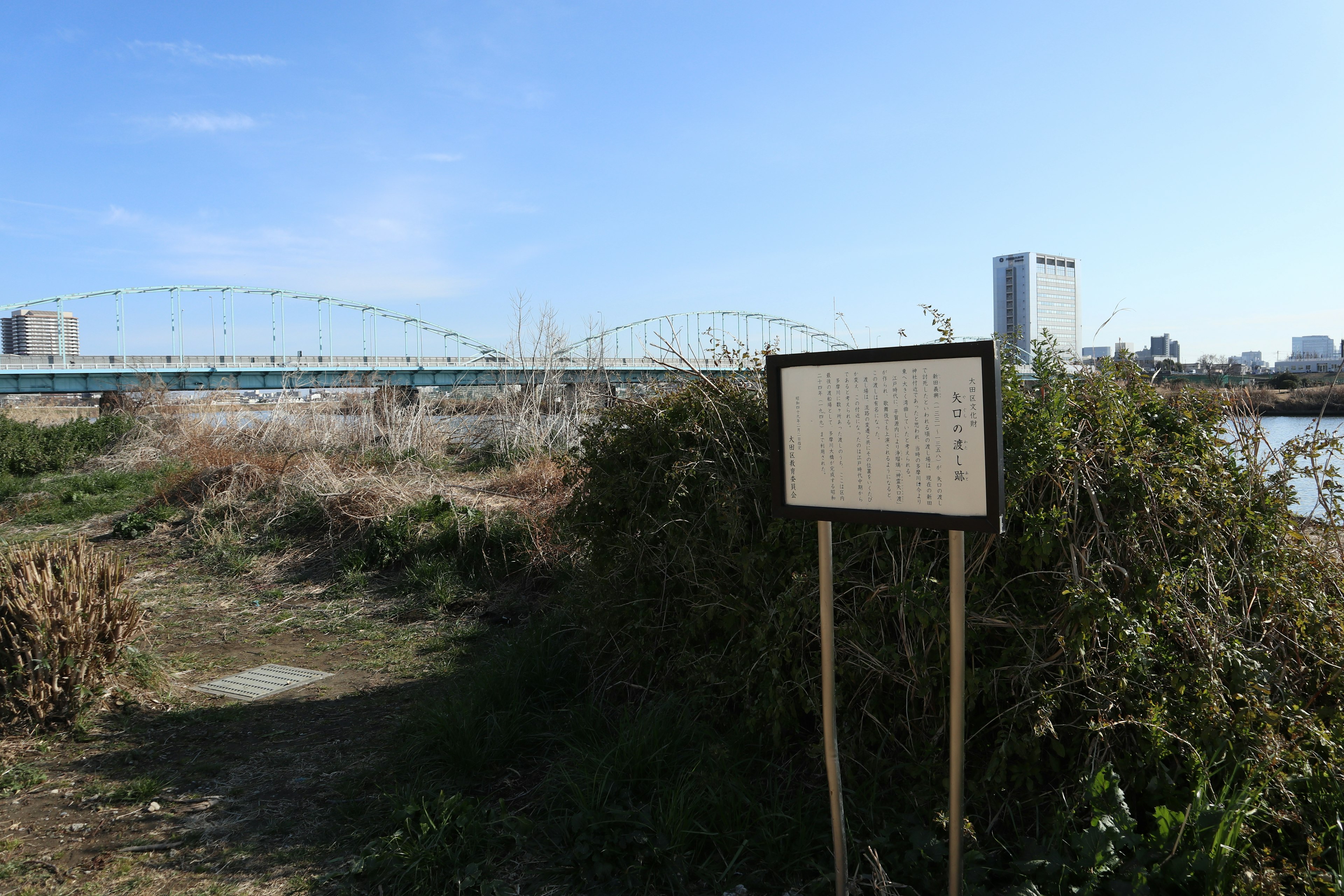 Scenic view of a riverside sign and a bridge