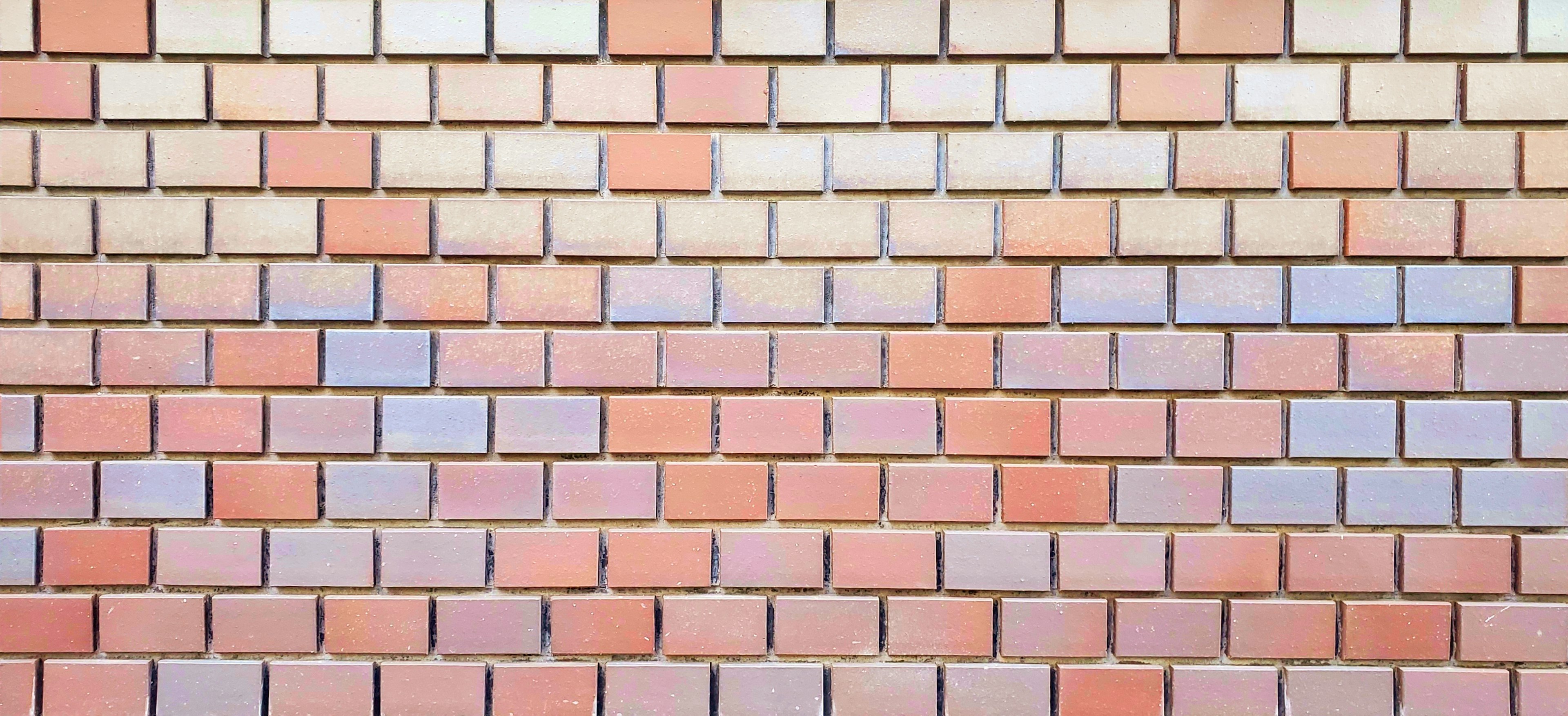 Textured wall made of various colored bricks