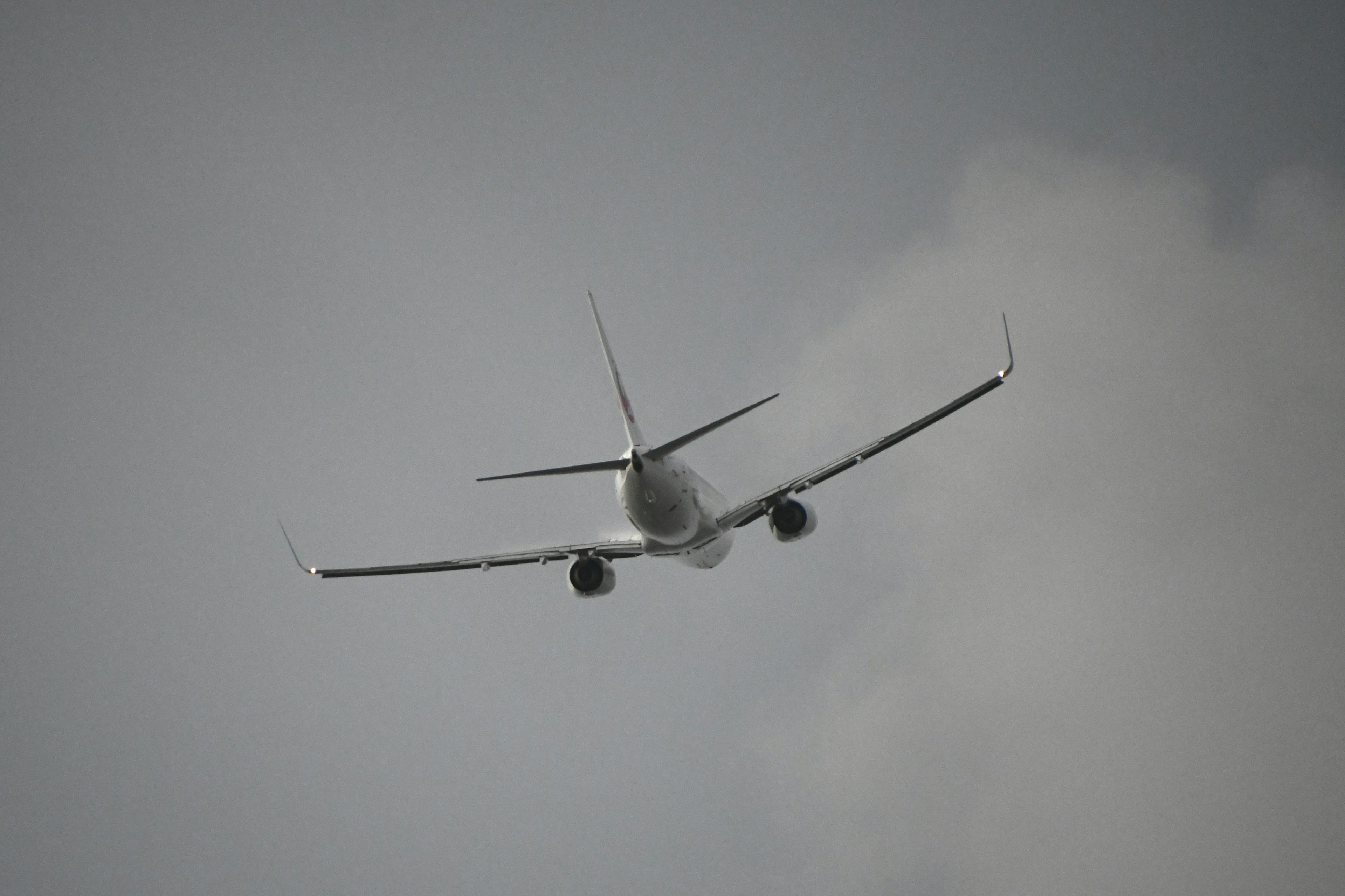 Airplane flying through cloudy sky