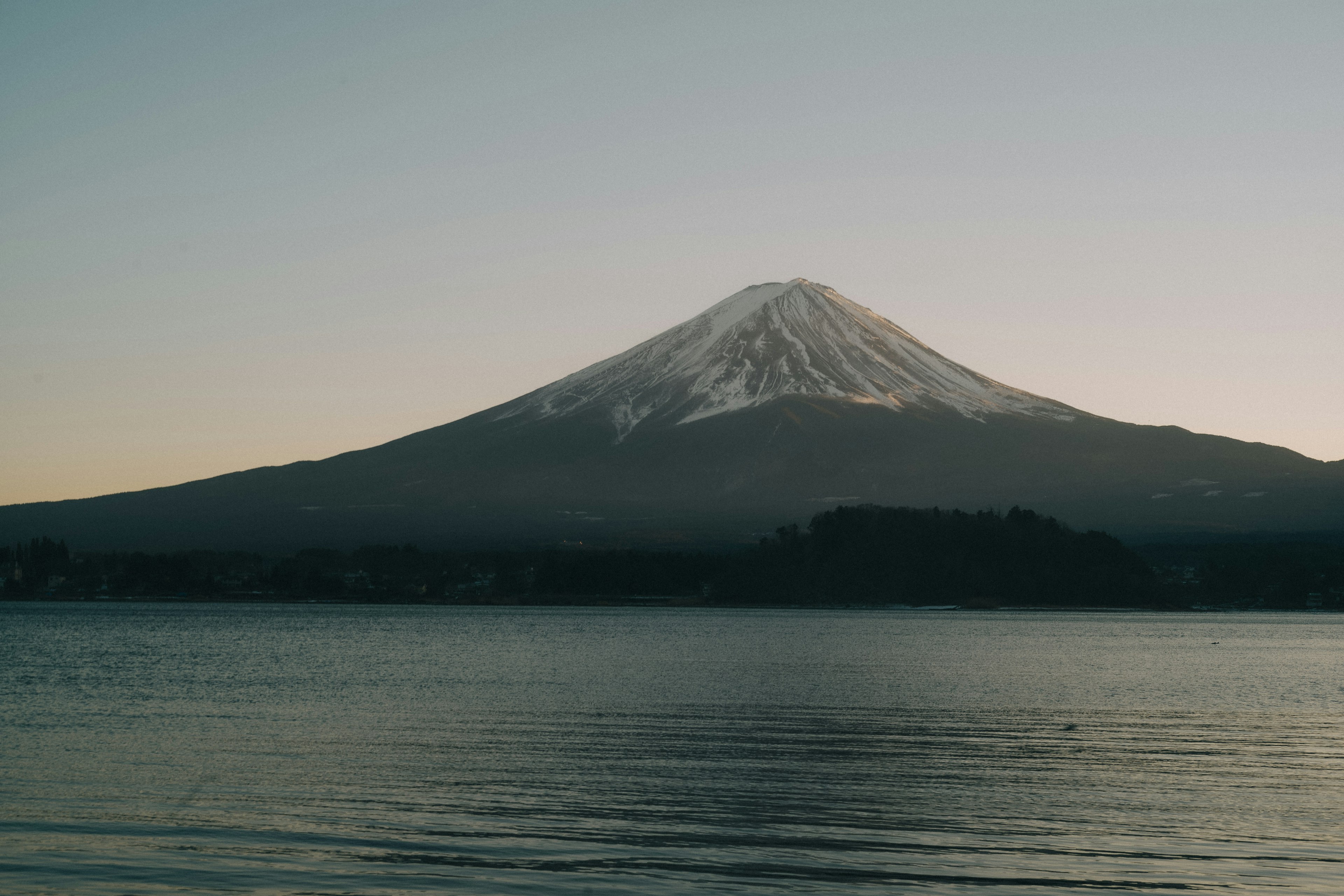 Snow-capped Mount Fuji reflected in a serene lake