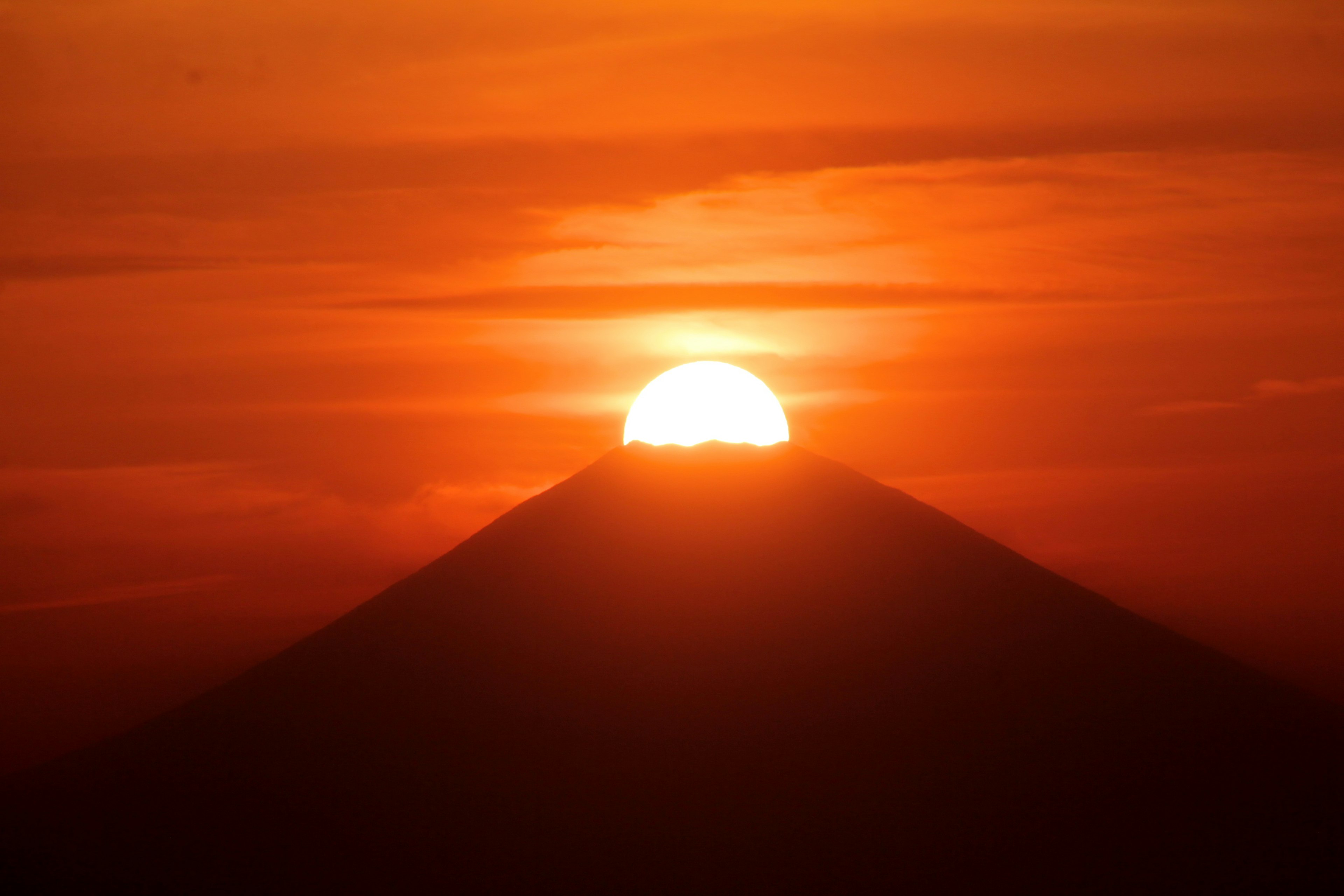 Beautiful sunset with the sun setting over a mountain