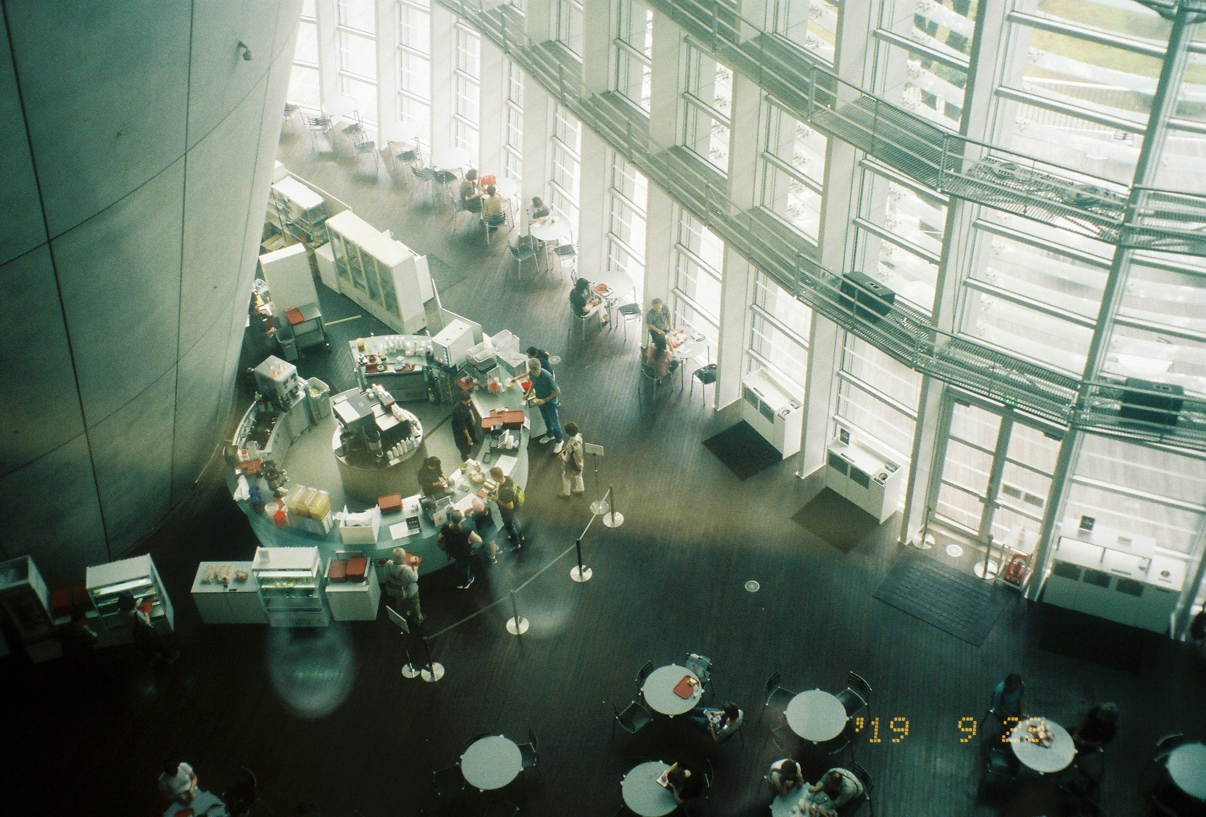 Spacious modern space filled with people Natural light streaming through large windows