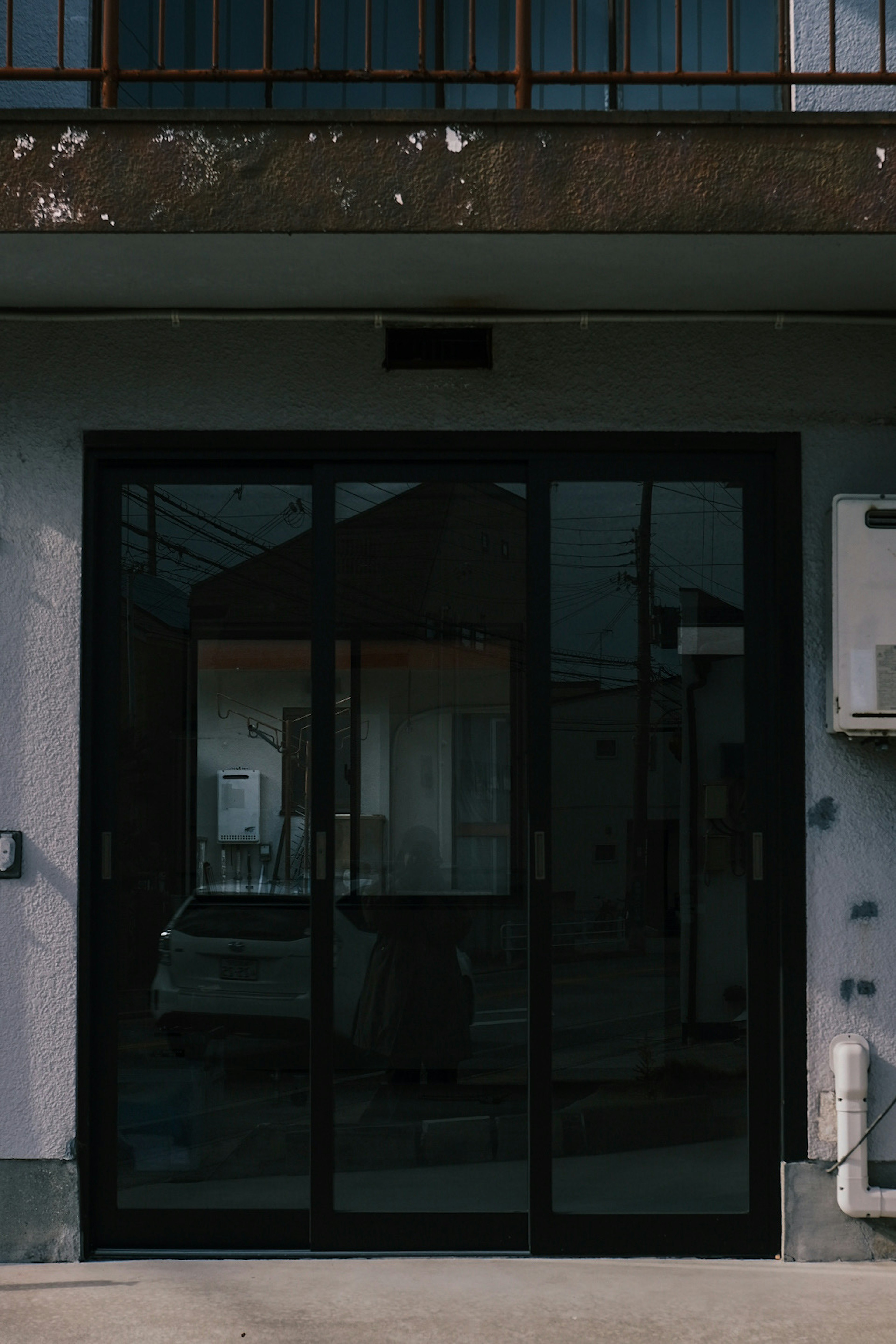 Exterior view of a building featuring a black glass automatic door