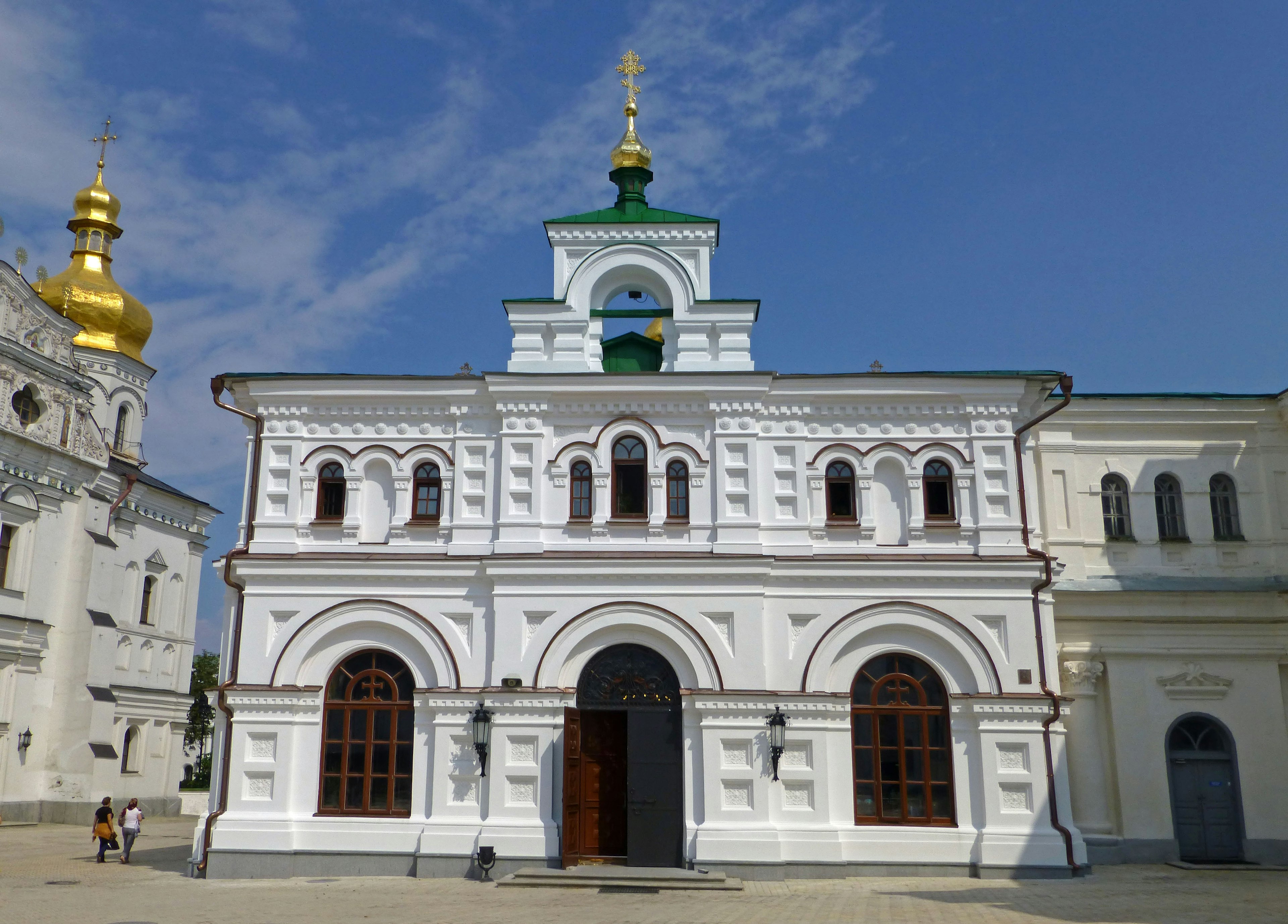 Church building with white walls and green roof