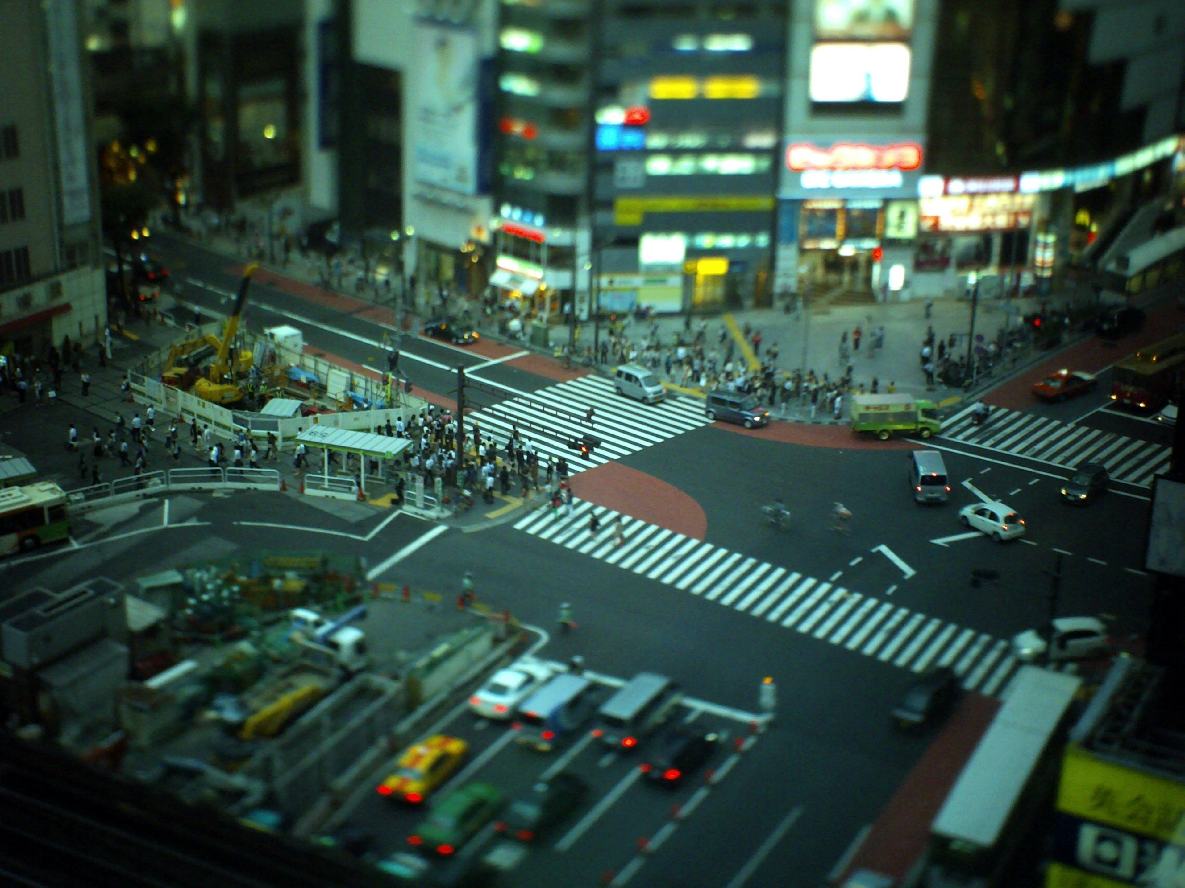 Night view of Shibuya Crossing with bustling pedestrians and vehicles