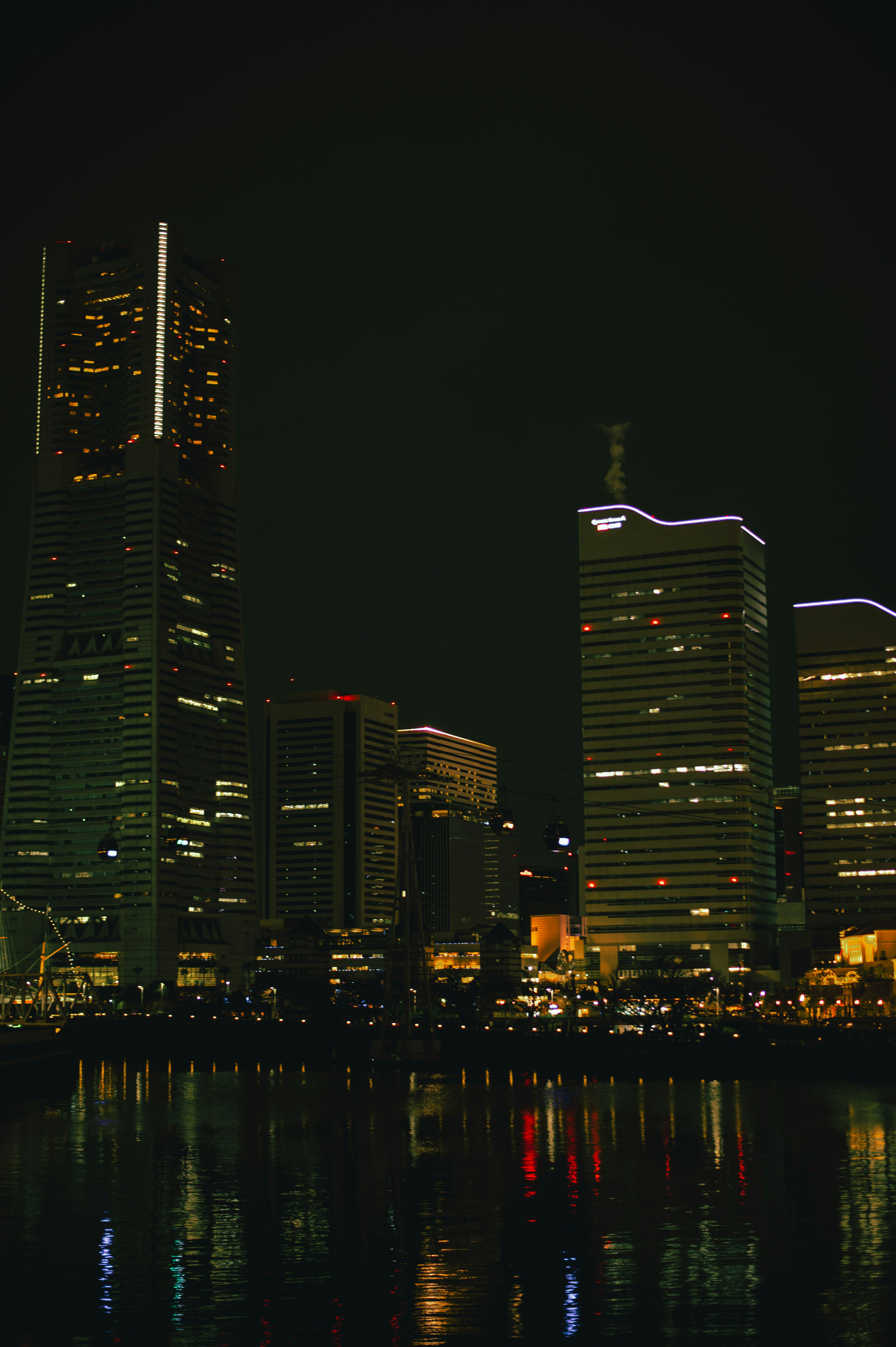 Night view of skyscrapers with reflections on the water