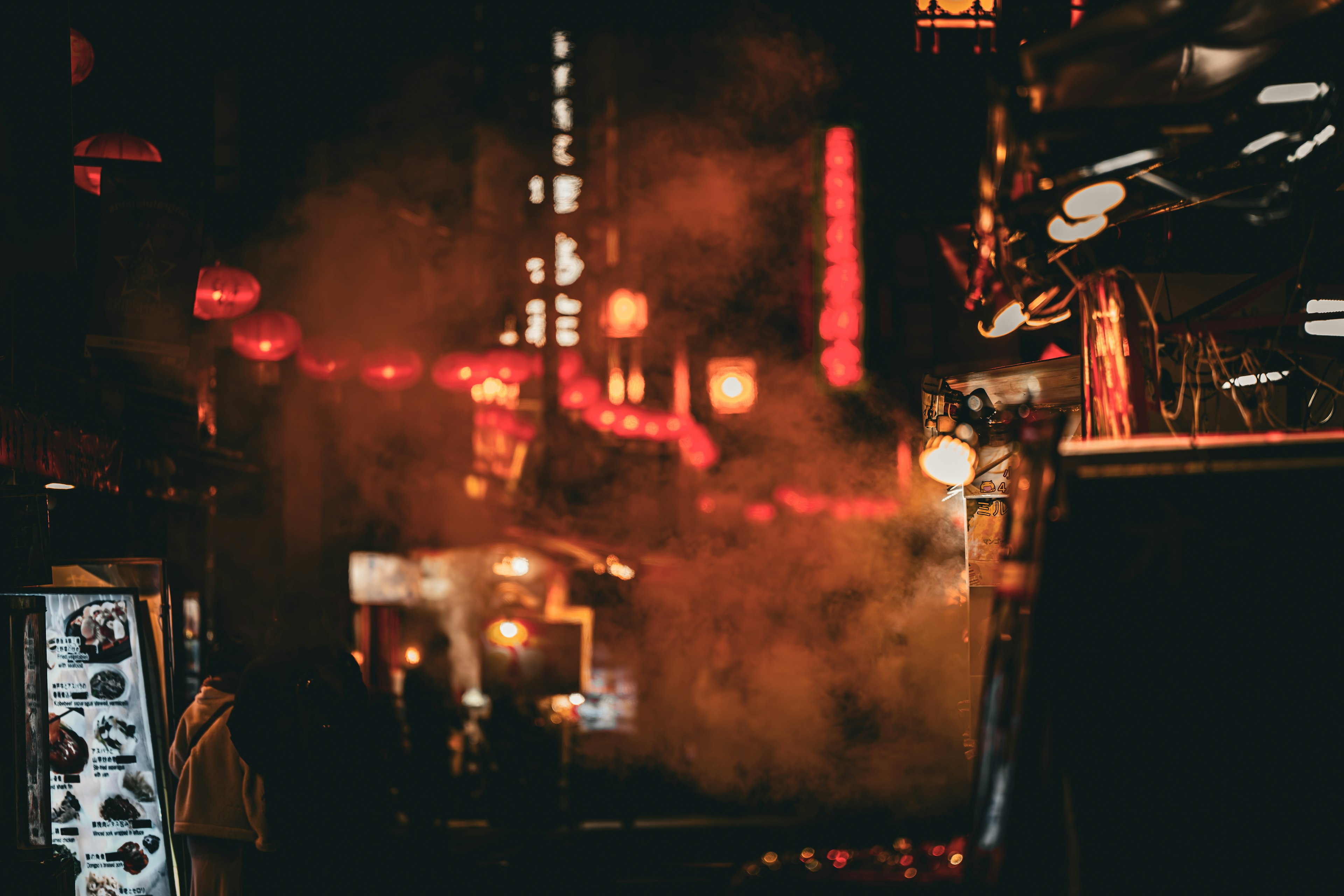 Night market scene with smoke and glowing red lanterns