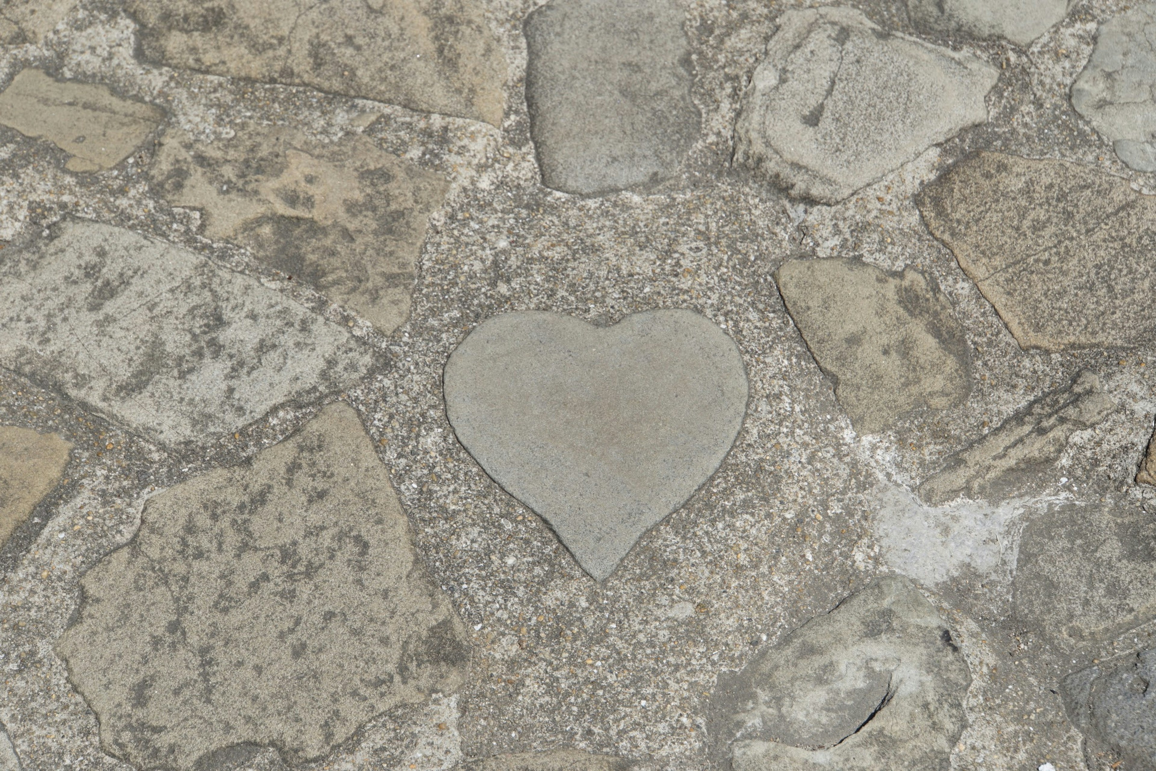 Heart-shaped stone embedded in a cobblestone path