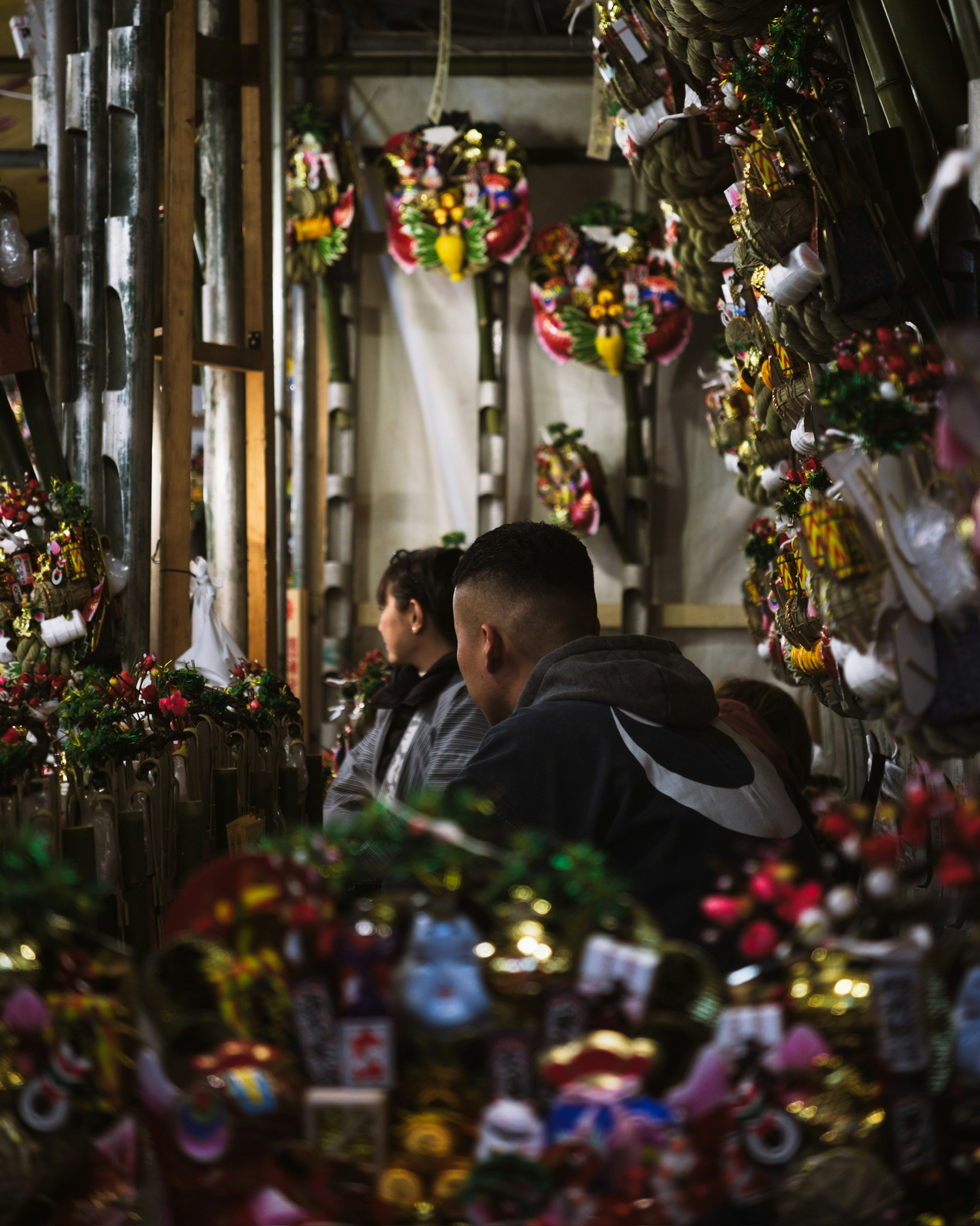 Scene of people surrounded by decorative items in a market