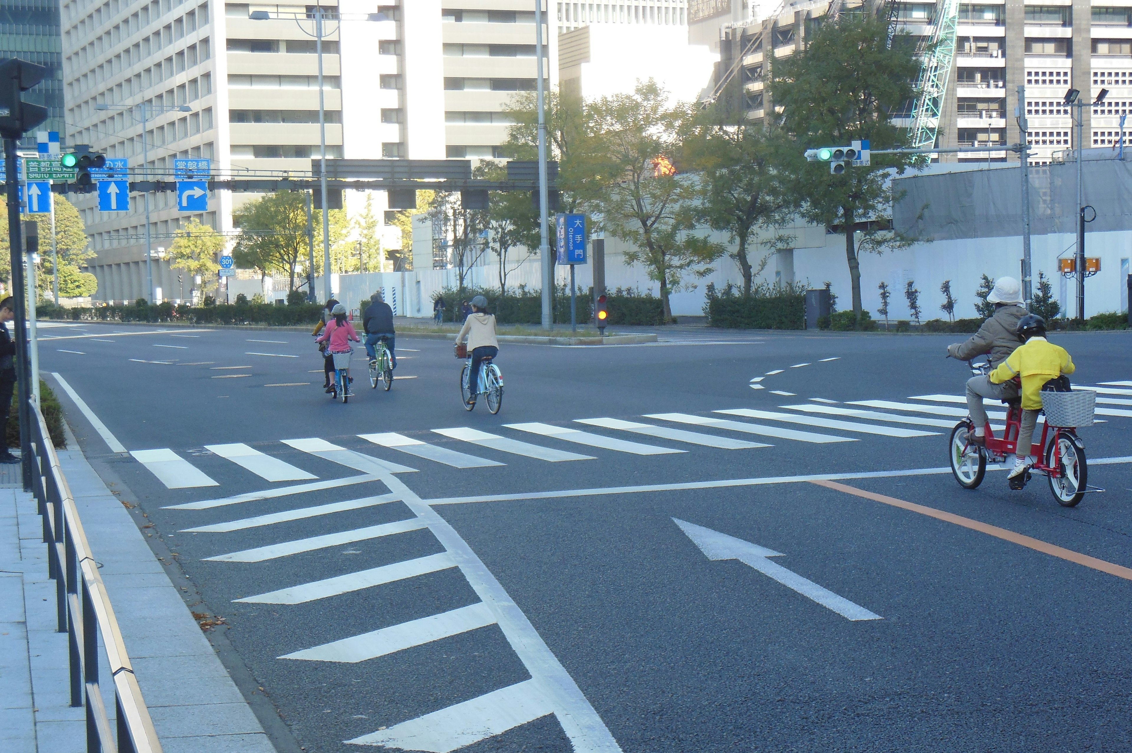 People riding bicycles at an intersection