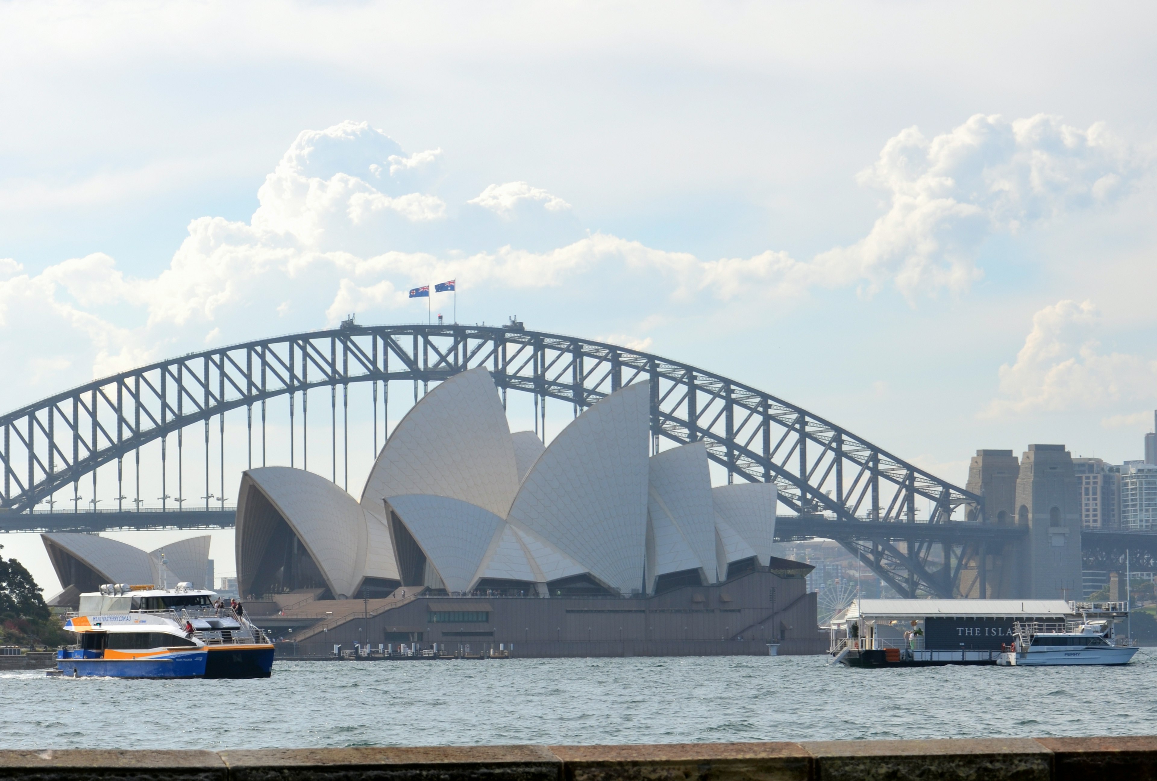 Sydney Opera House and Harbour Bridge with boats in the foreground