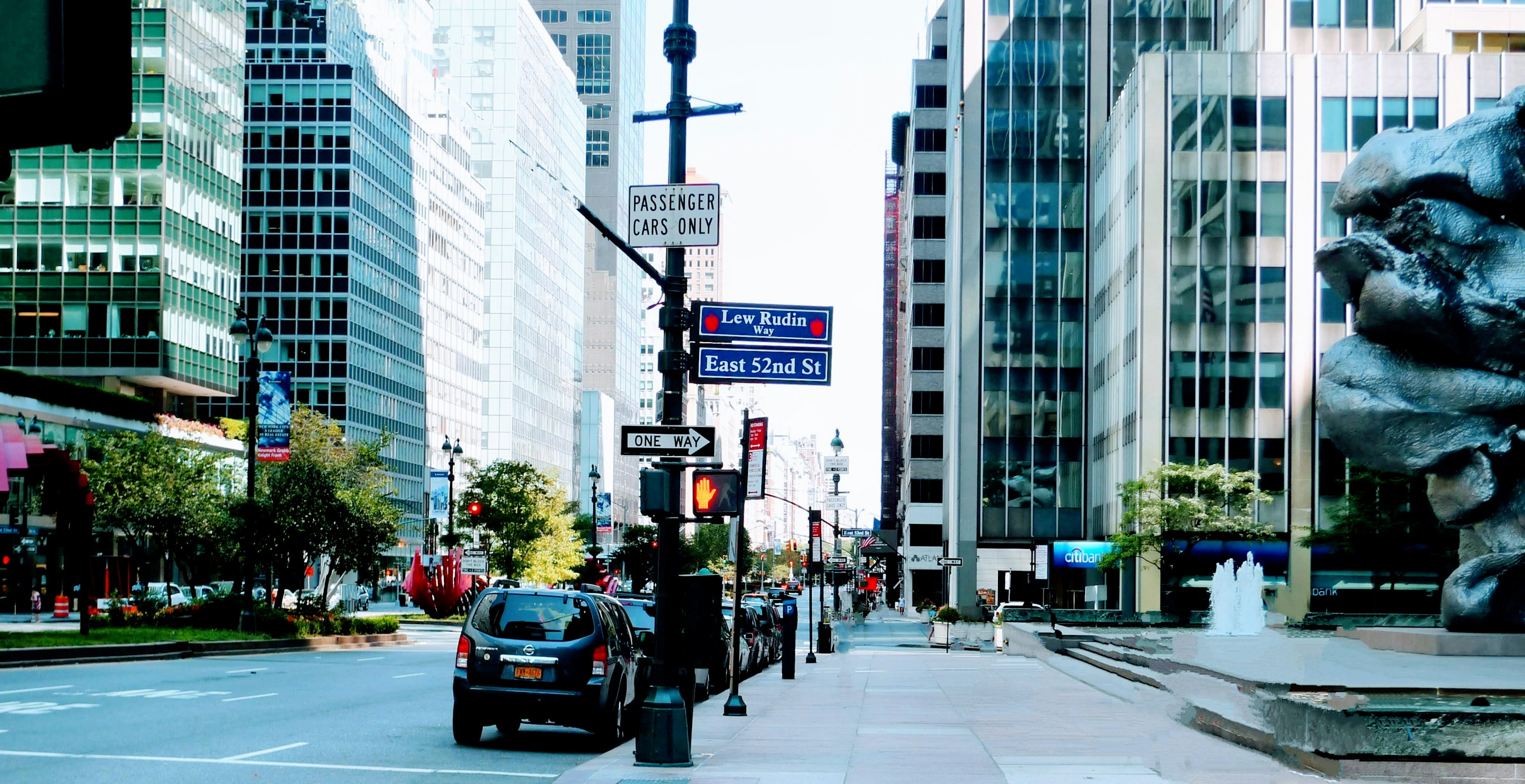 City street view featuring a sculpture and skyscrapers