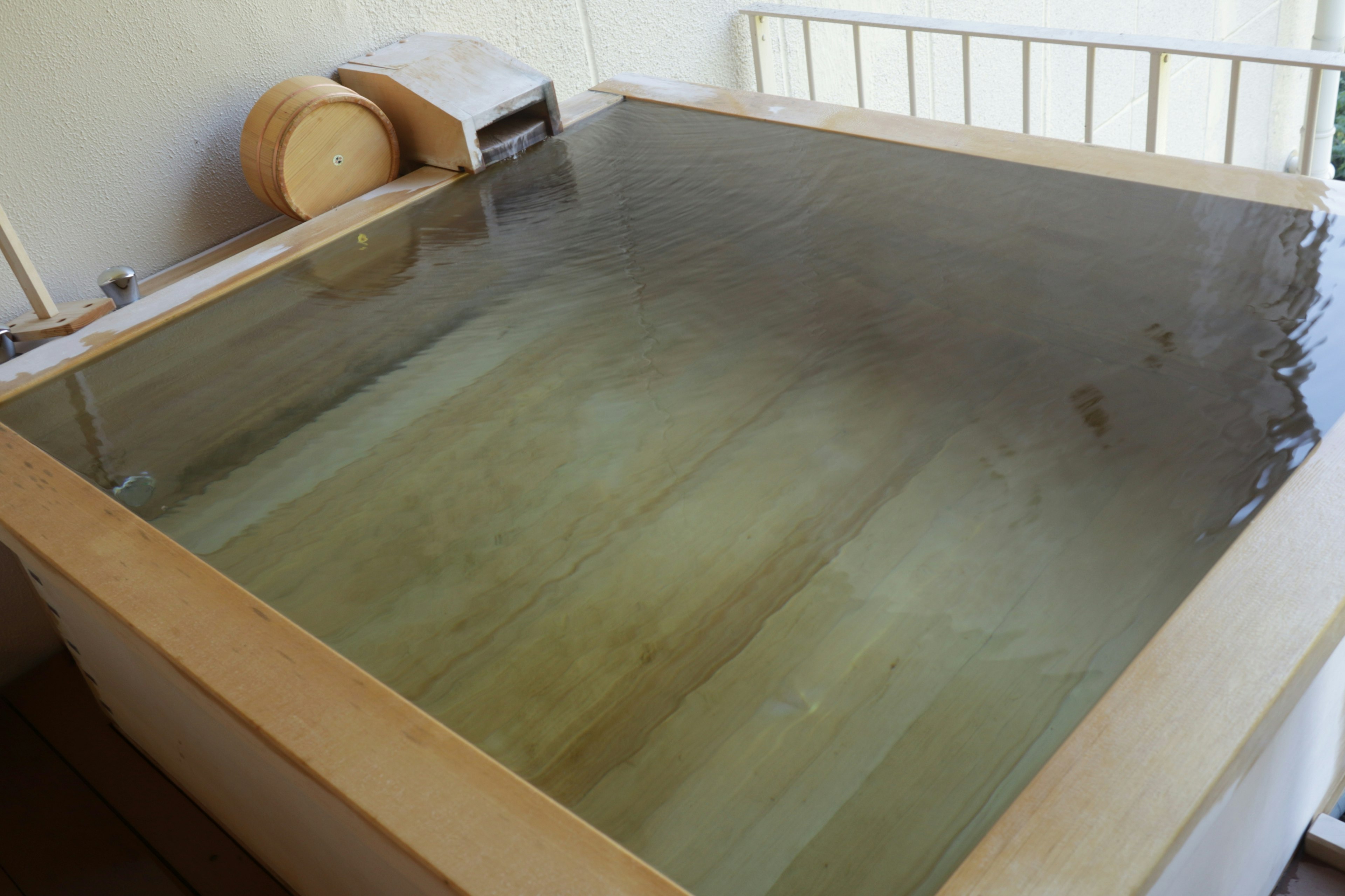 Image of a wooden hot spring bath filled with water