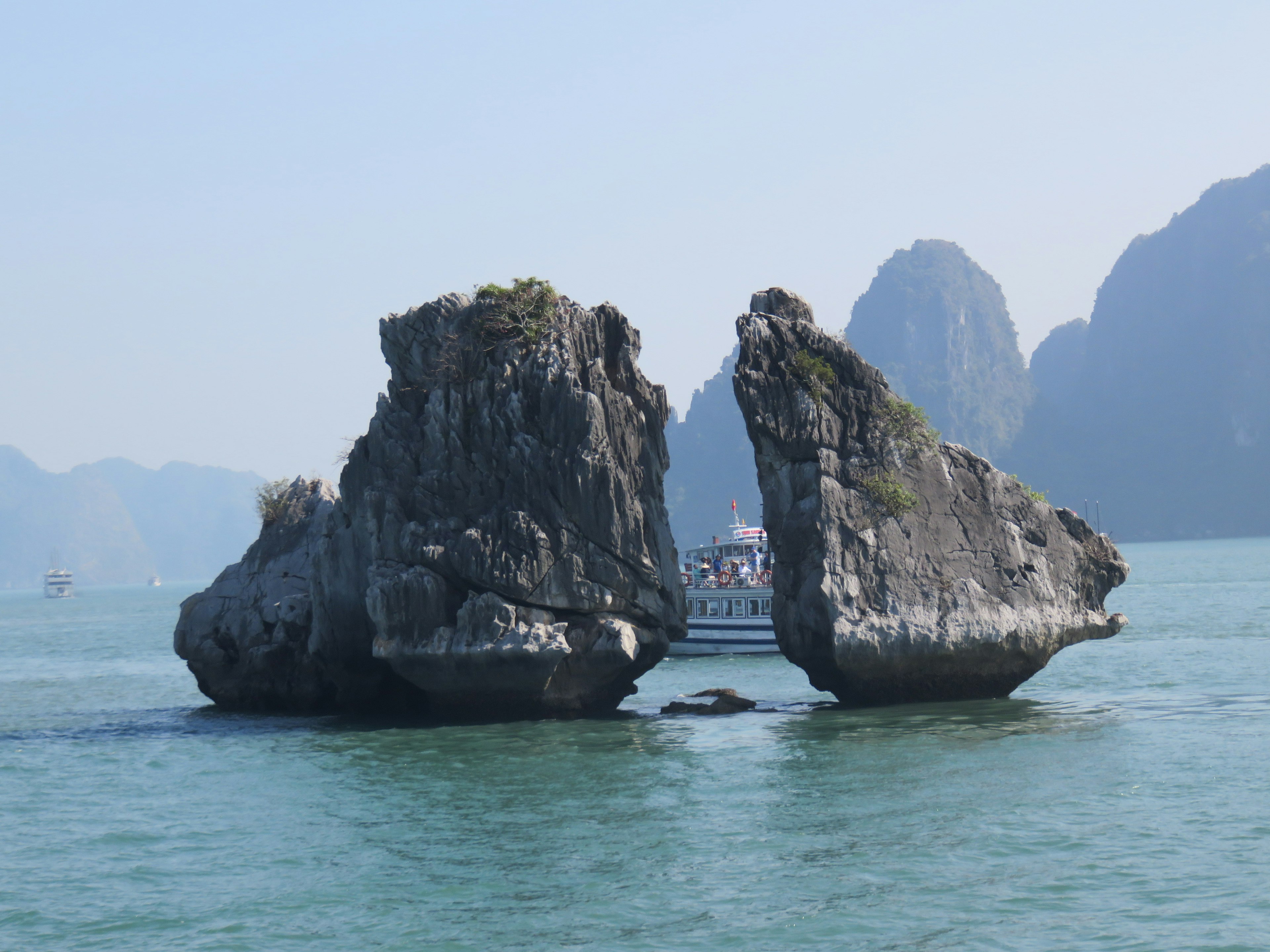 Unique shaped rocks in the sea with distant mountains