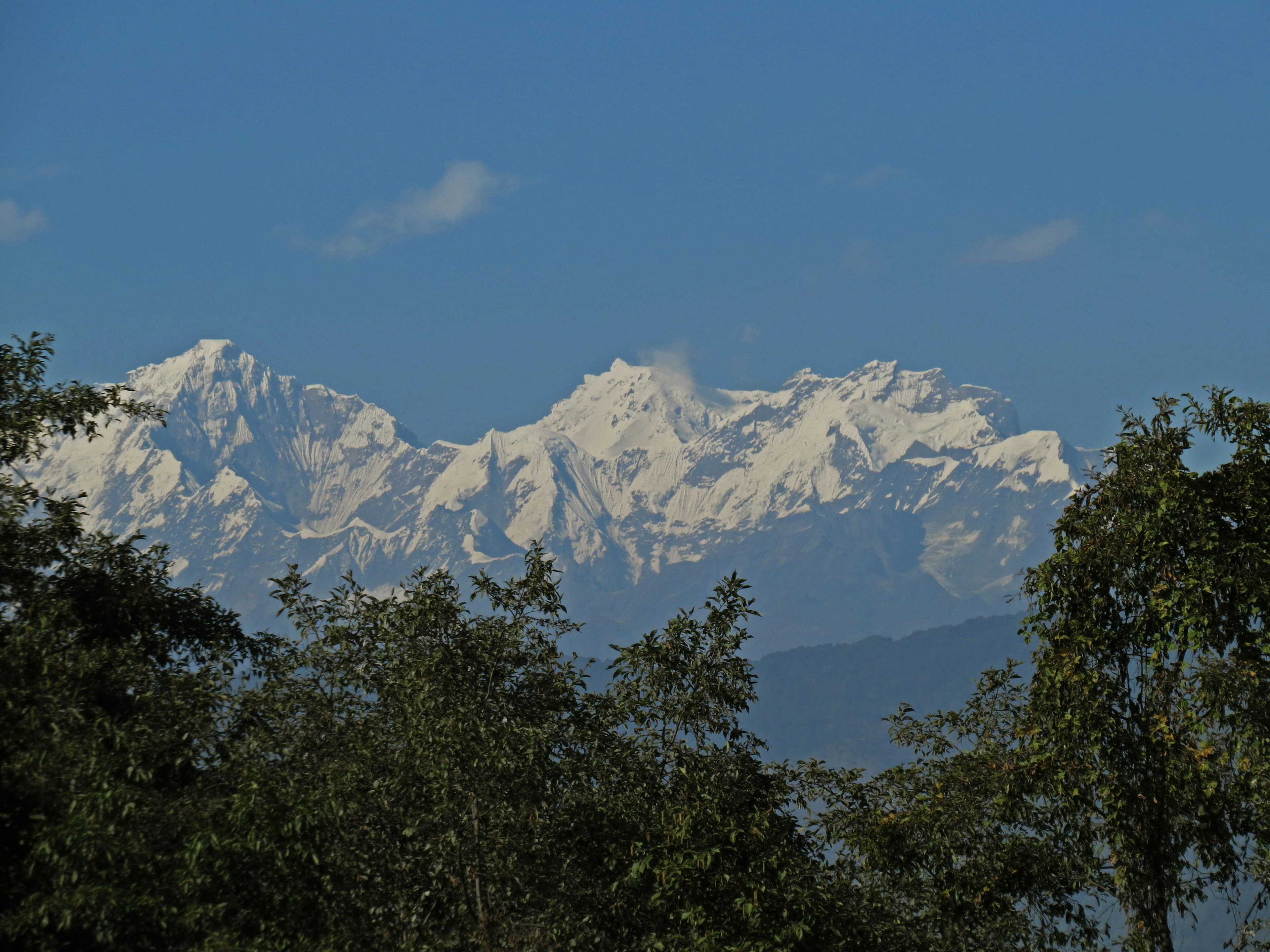 Scenic view of snow-capped mountains under a clear blue sky