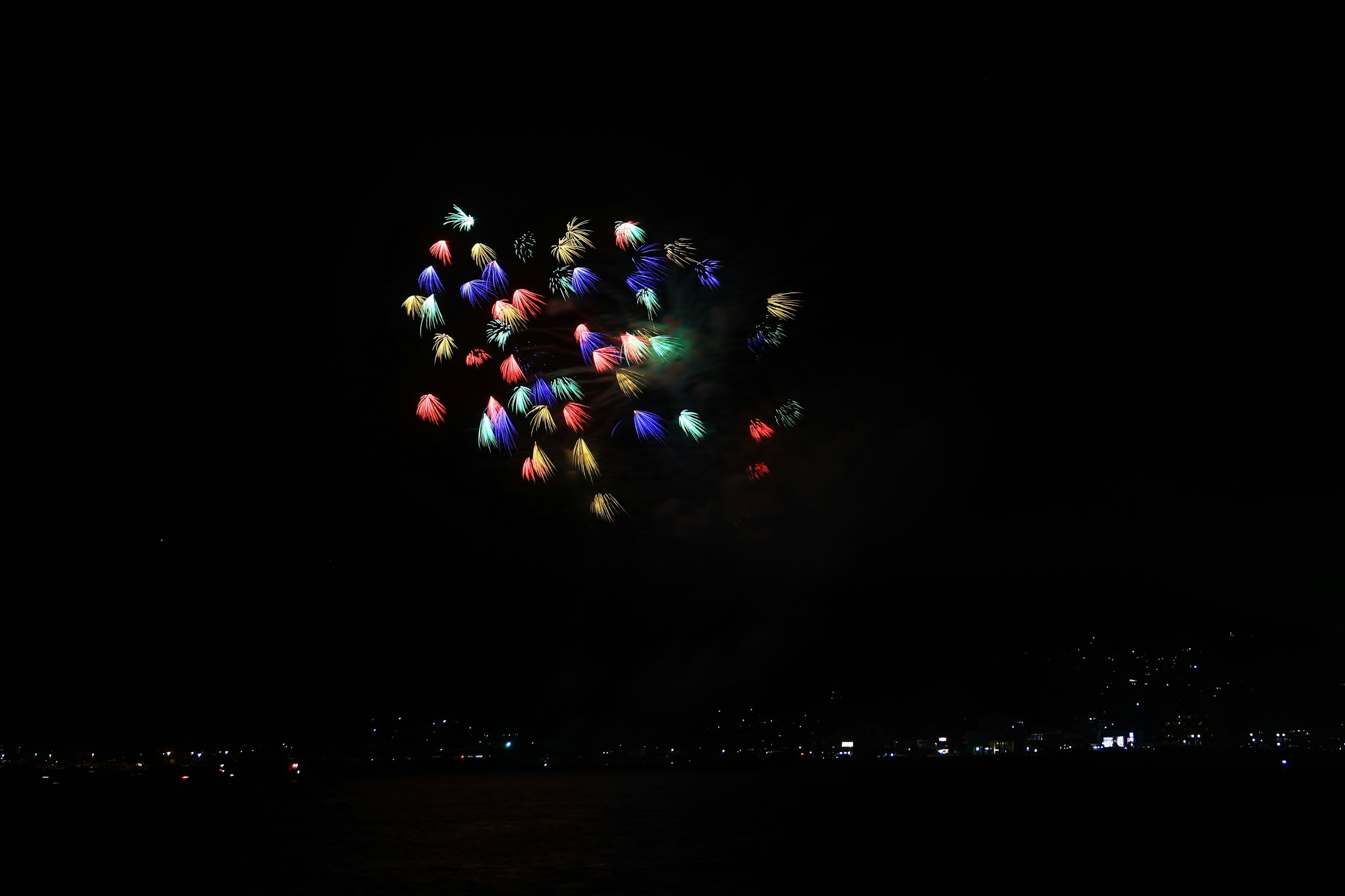 Colorful lanterns floating in the night sky