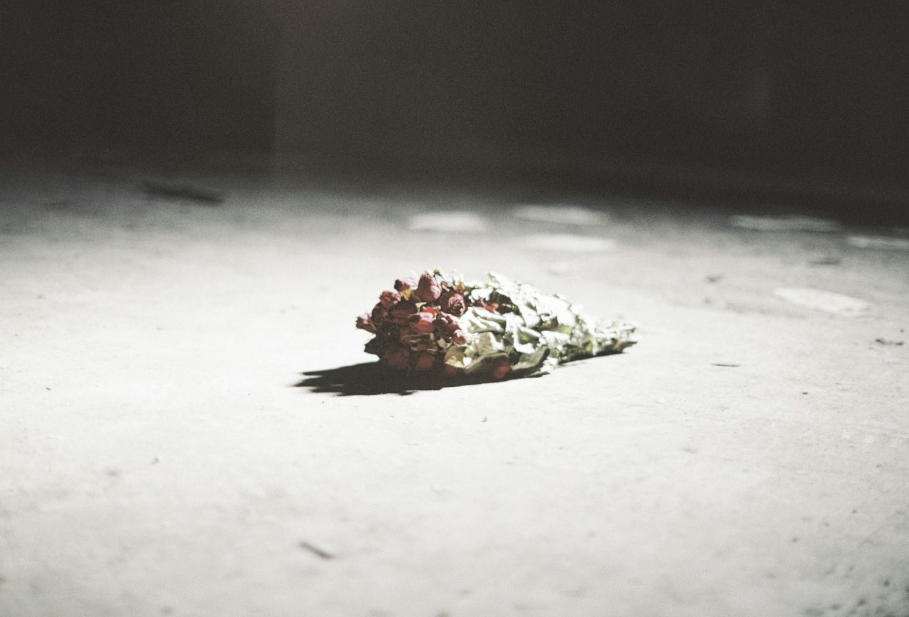 Close-up of a wilted bouquet lying on the ground