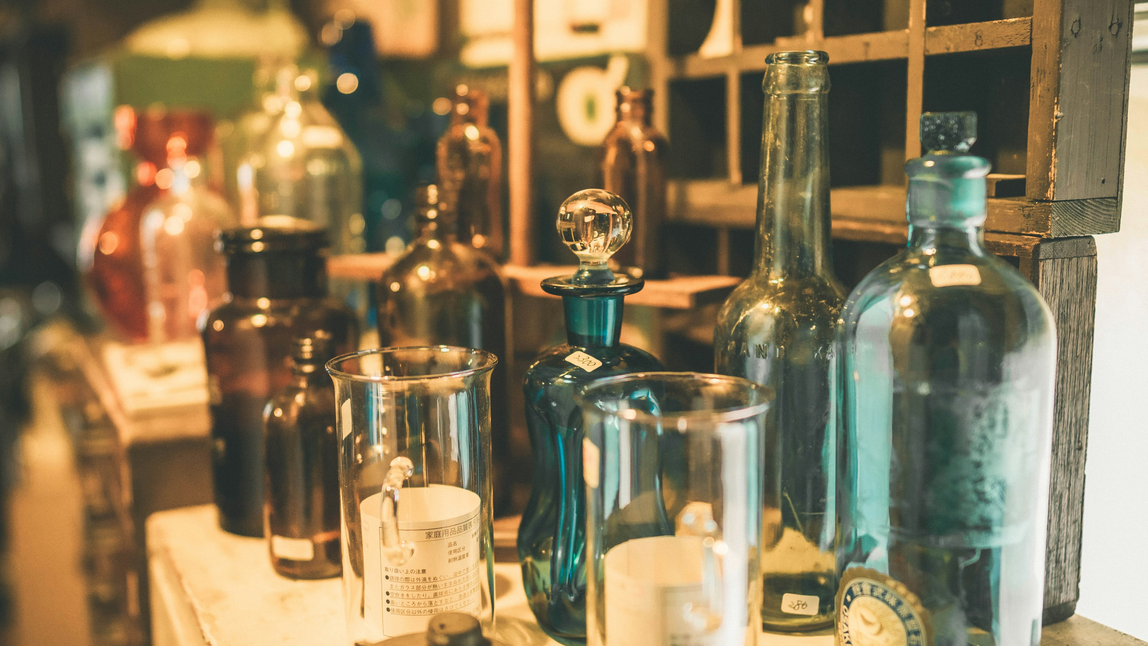 A collection of colorful vintage bottles displayed in an antique shop