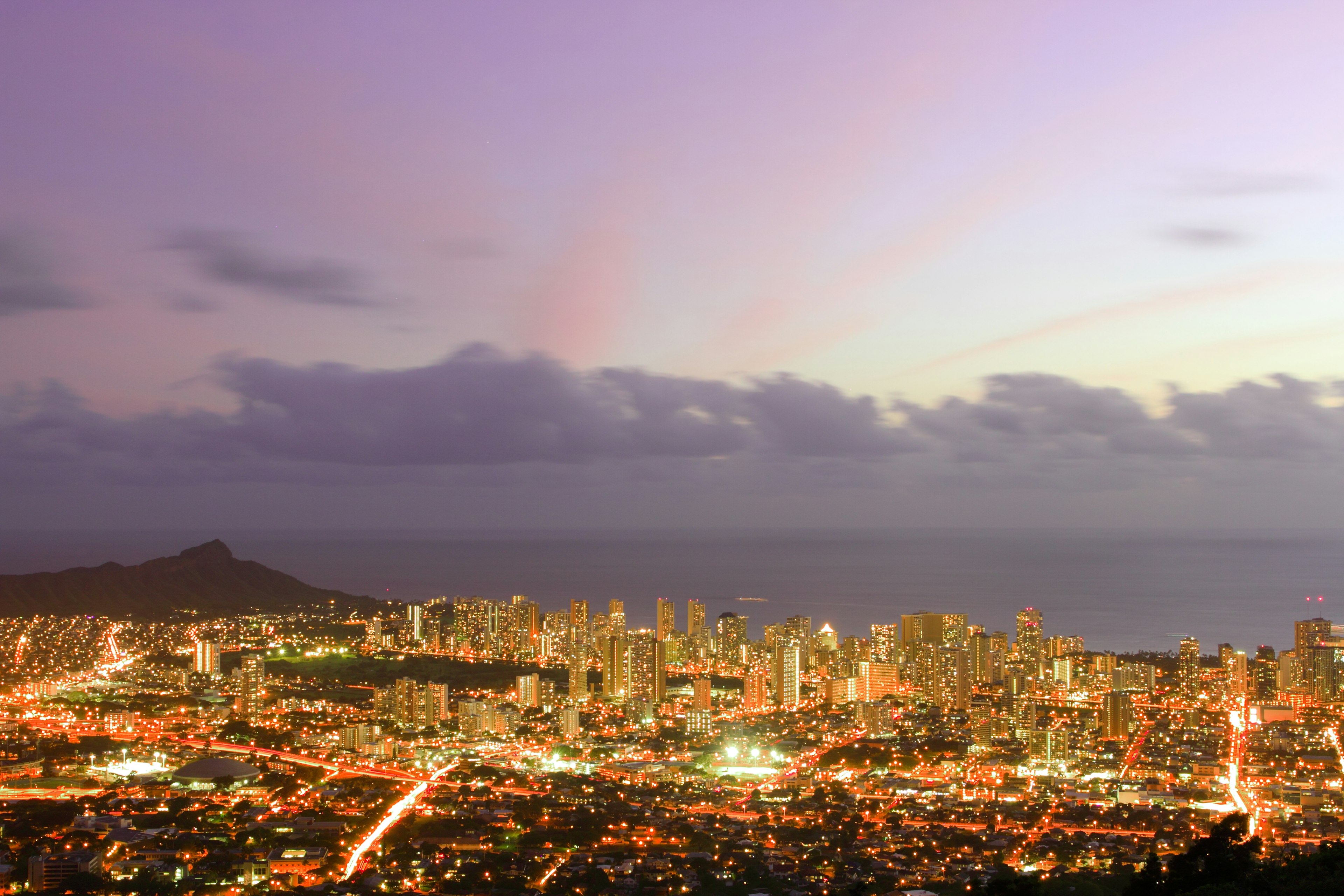 Honolulu skyline at dusk featuring skyscrapers and ocean