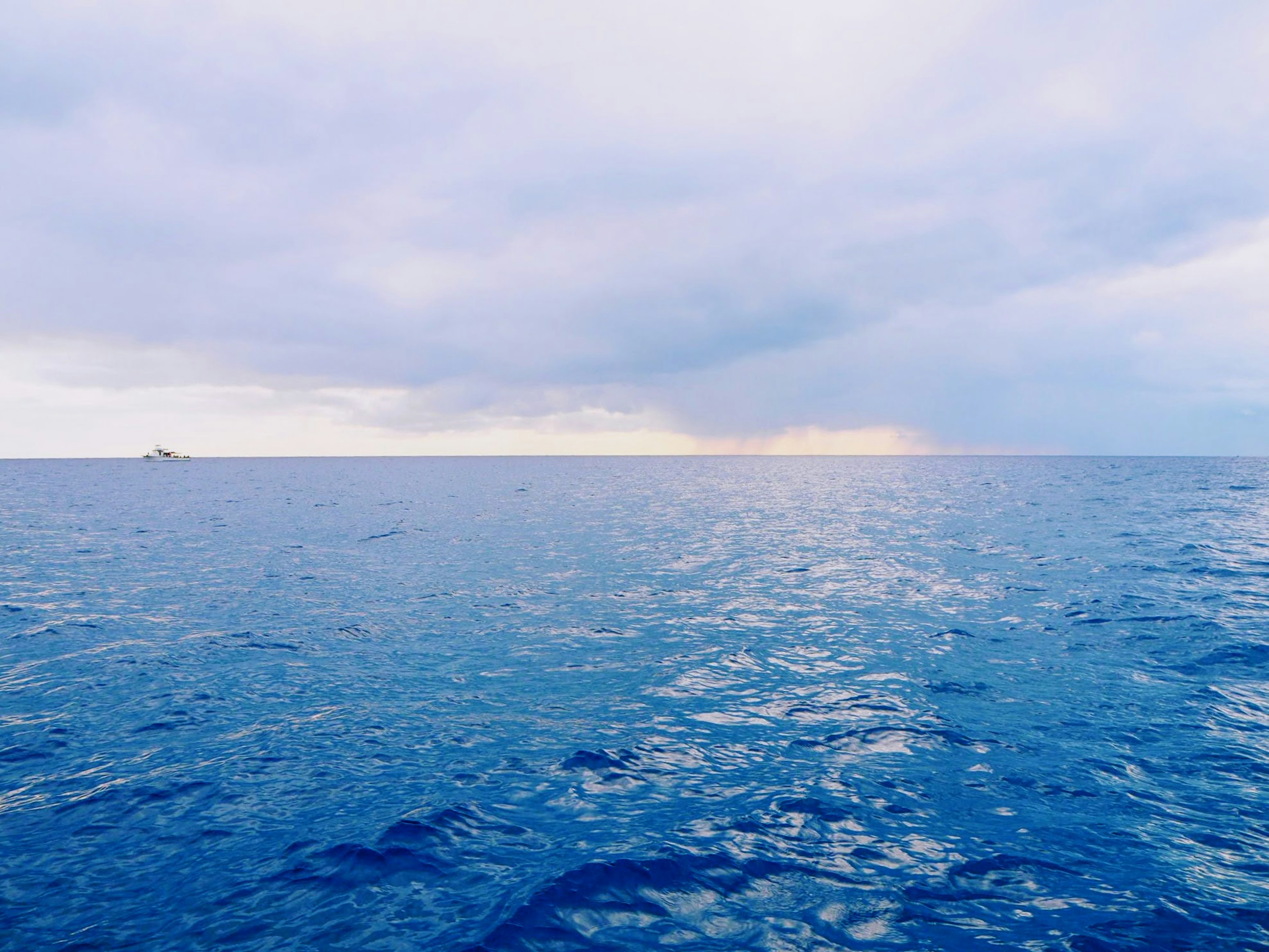 Expansive view of a blue ocean under a bright sky